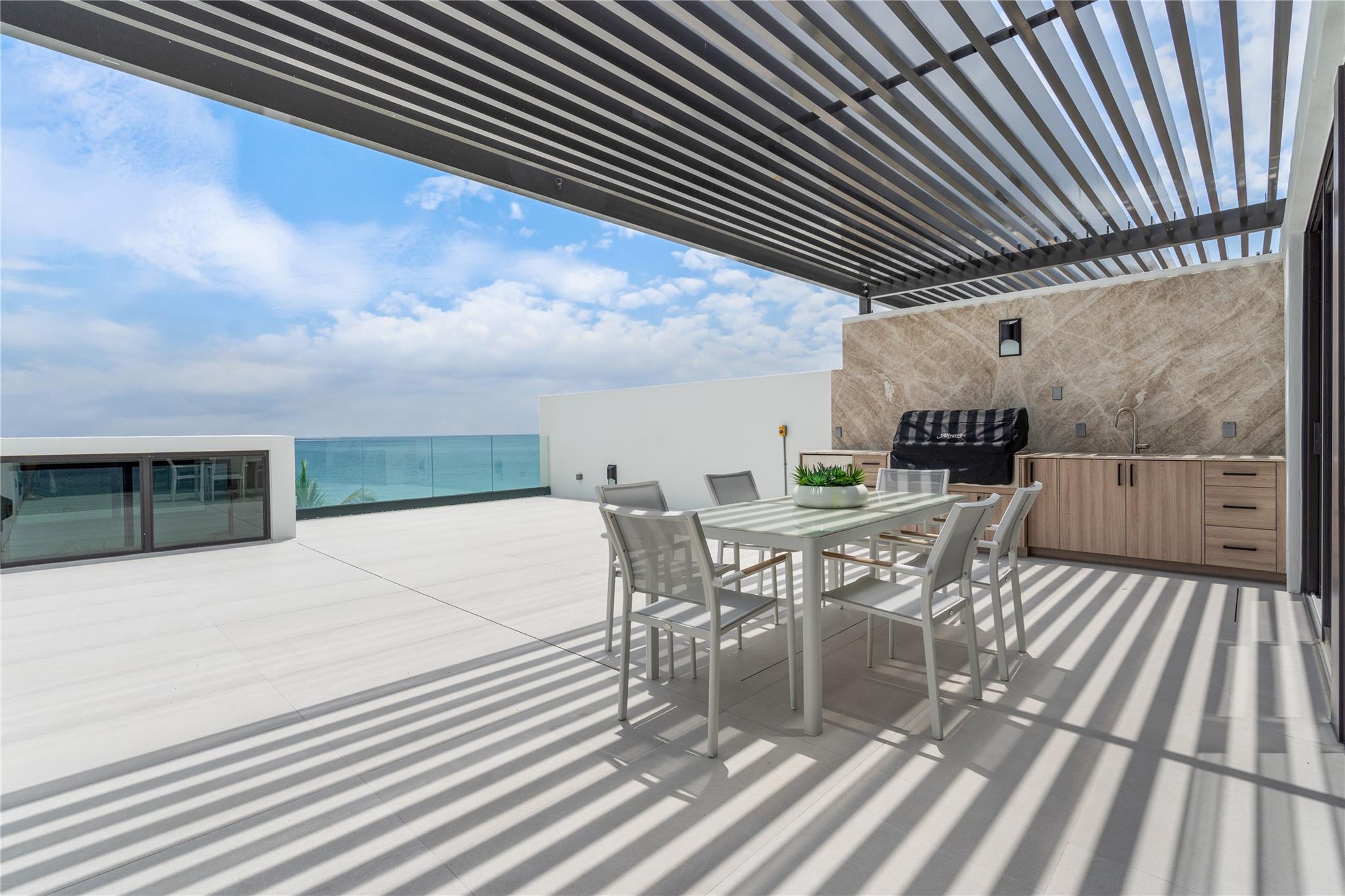 East facing roof-top terrace with ocean views and grill.
