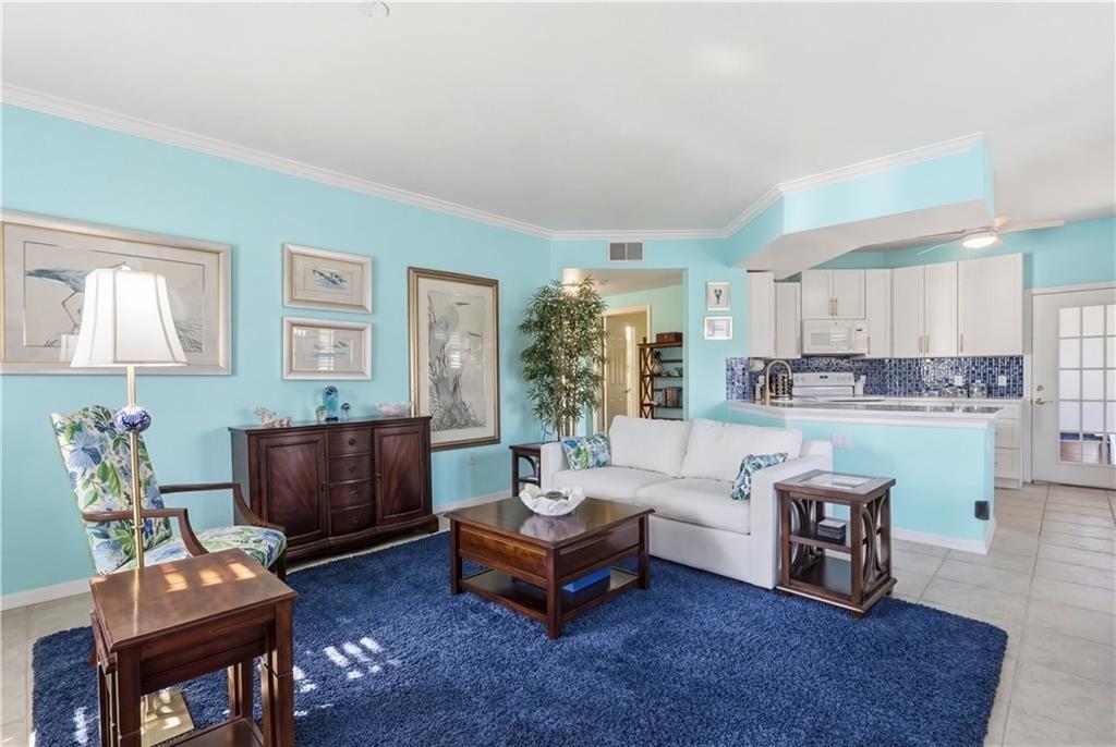 Welcome home to this Living room flanks the upgraded kitchen with soft close cabinet drawers/door, bronze fixtures and more.