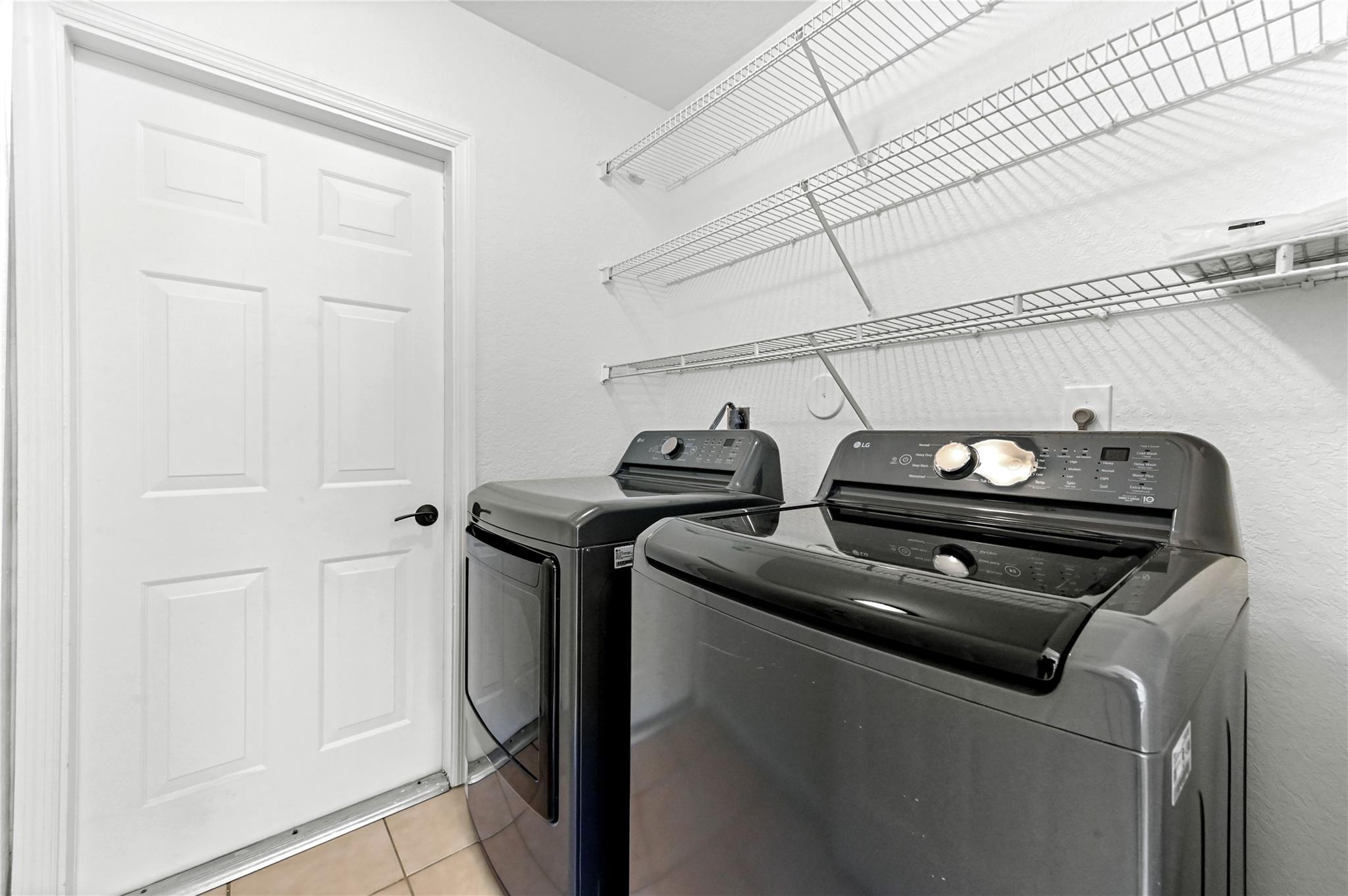 Inside utility room with brand new washer/dryer