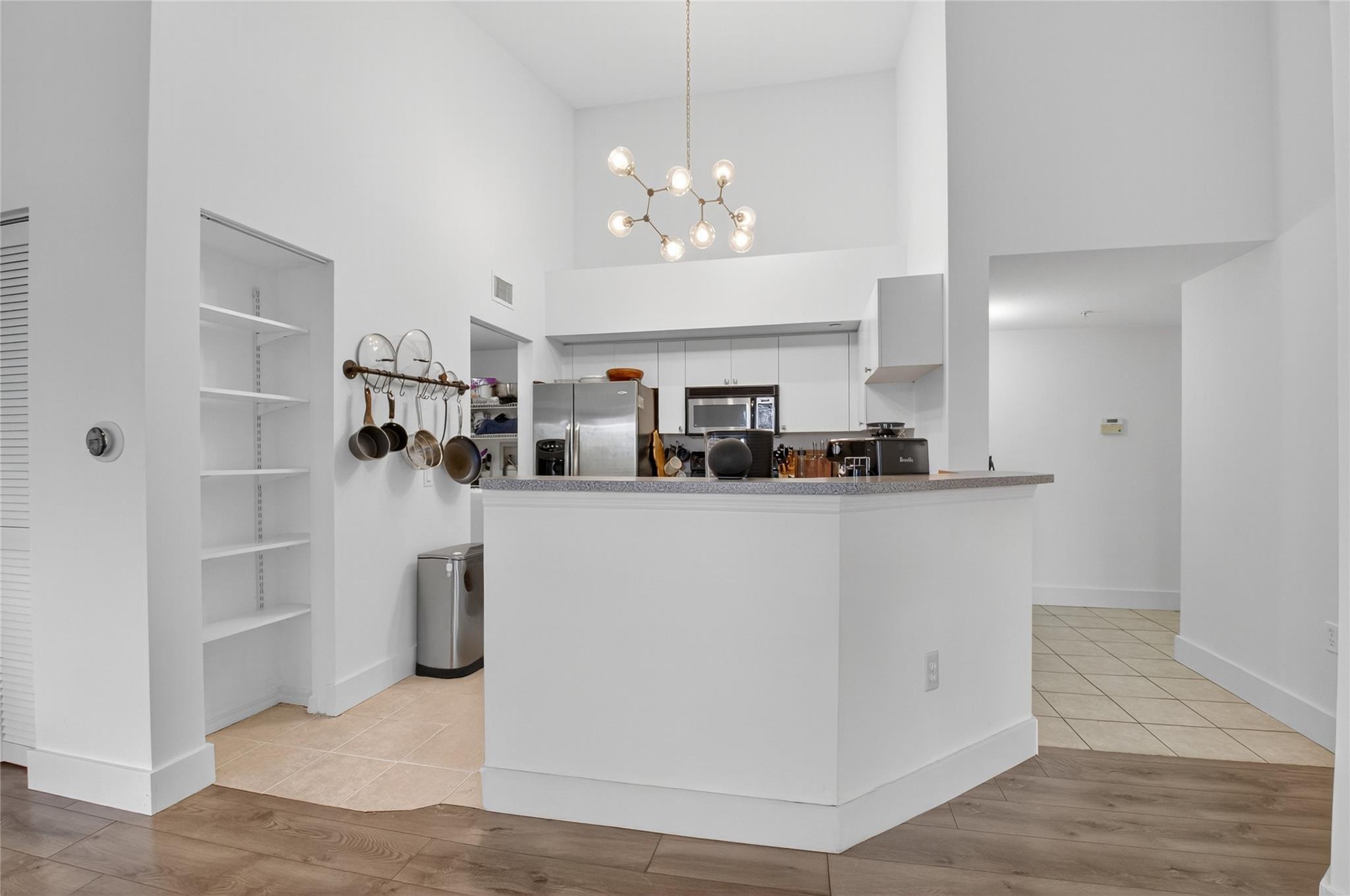 The open kitchen features a breakfast bar and over looks the Living/Dining Room.
