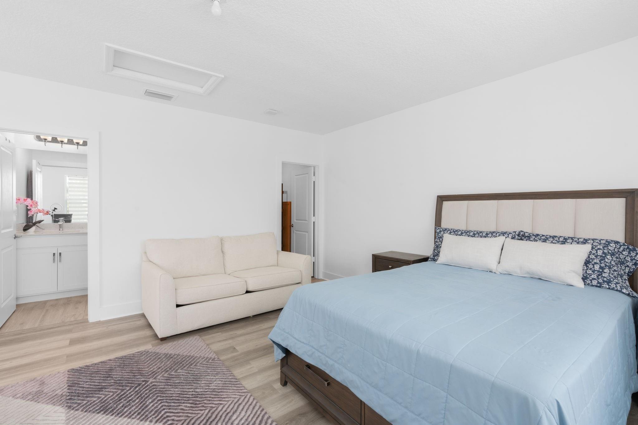 Continuous Luxury Vinyl Tile Throughout the Second Floor Primary Bedroom including the En Suite Bathroom and Walk In Closet.