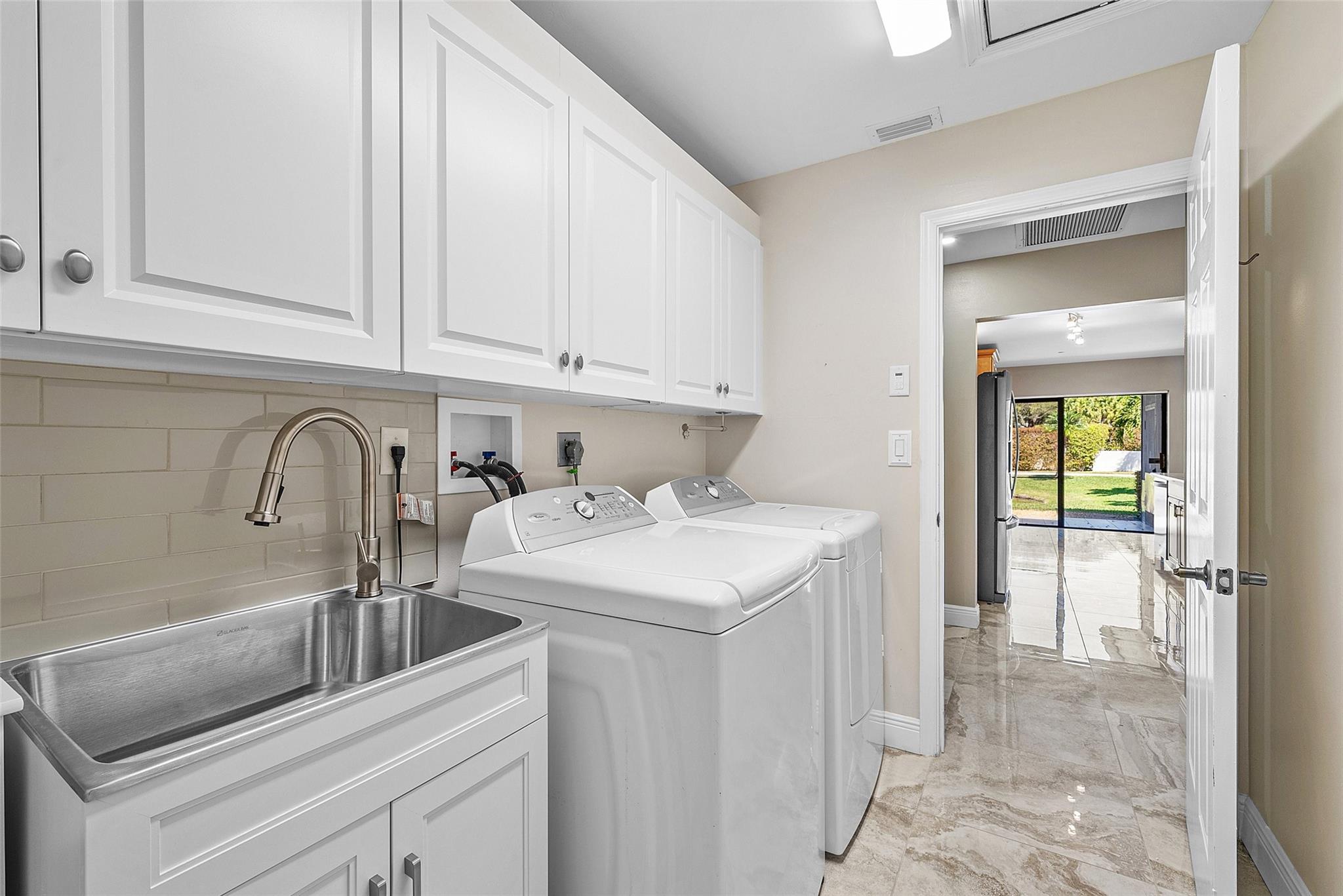 Laundry room with new sink- tankless heater in laundry cabinet