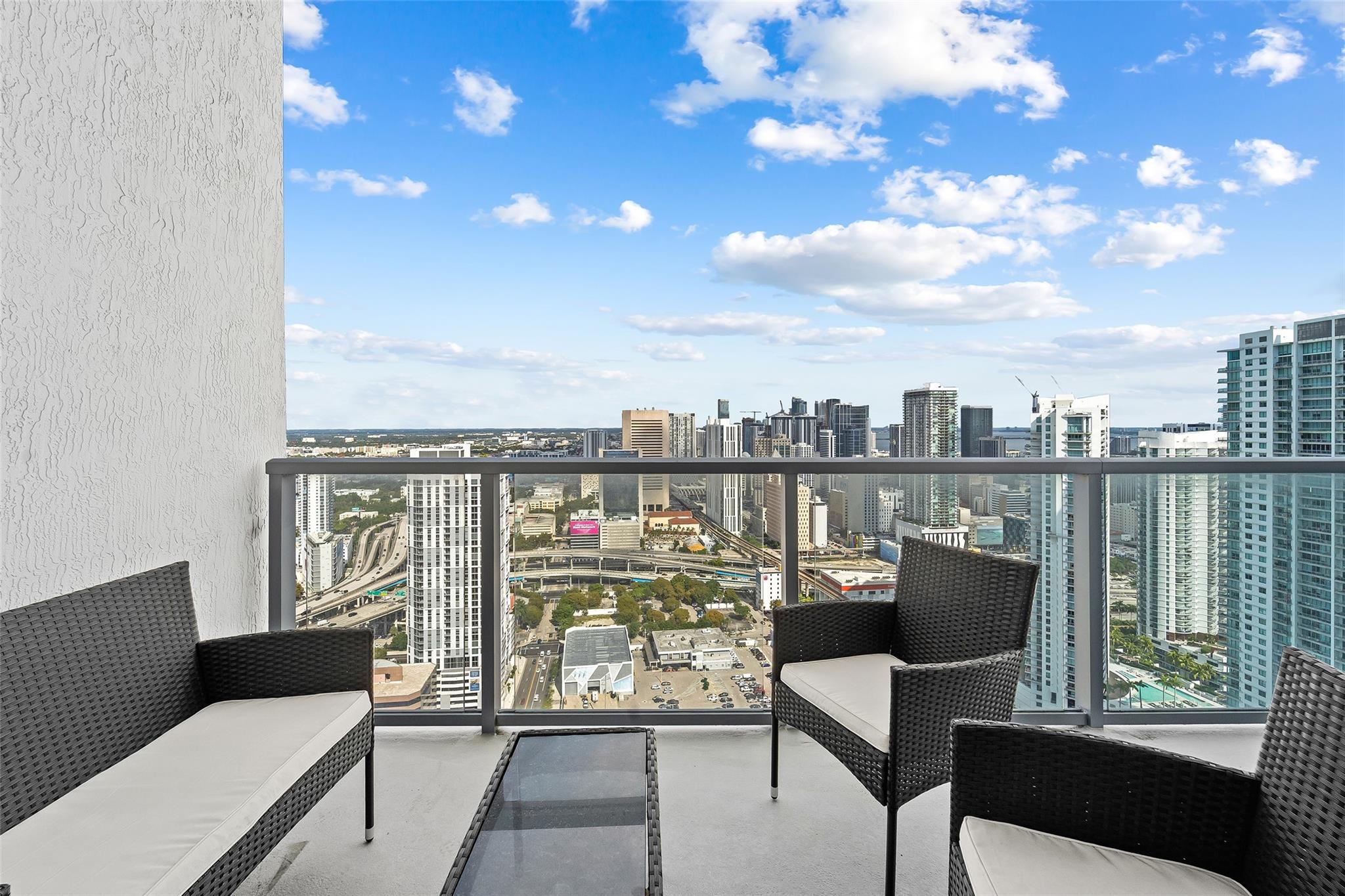 Oversized balcony with room for multiple outdoor spaces, panoramic views of Miami from East to West