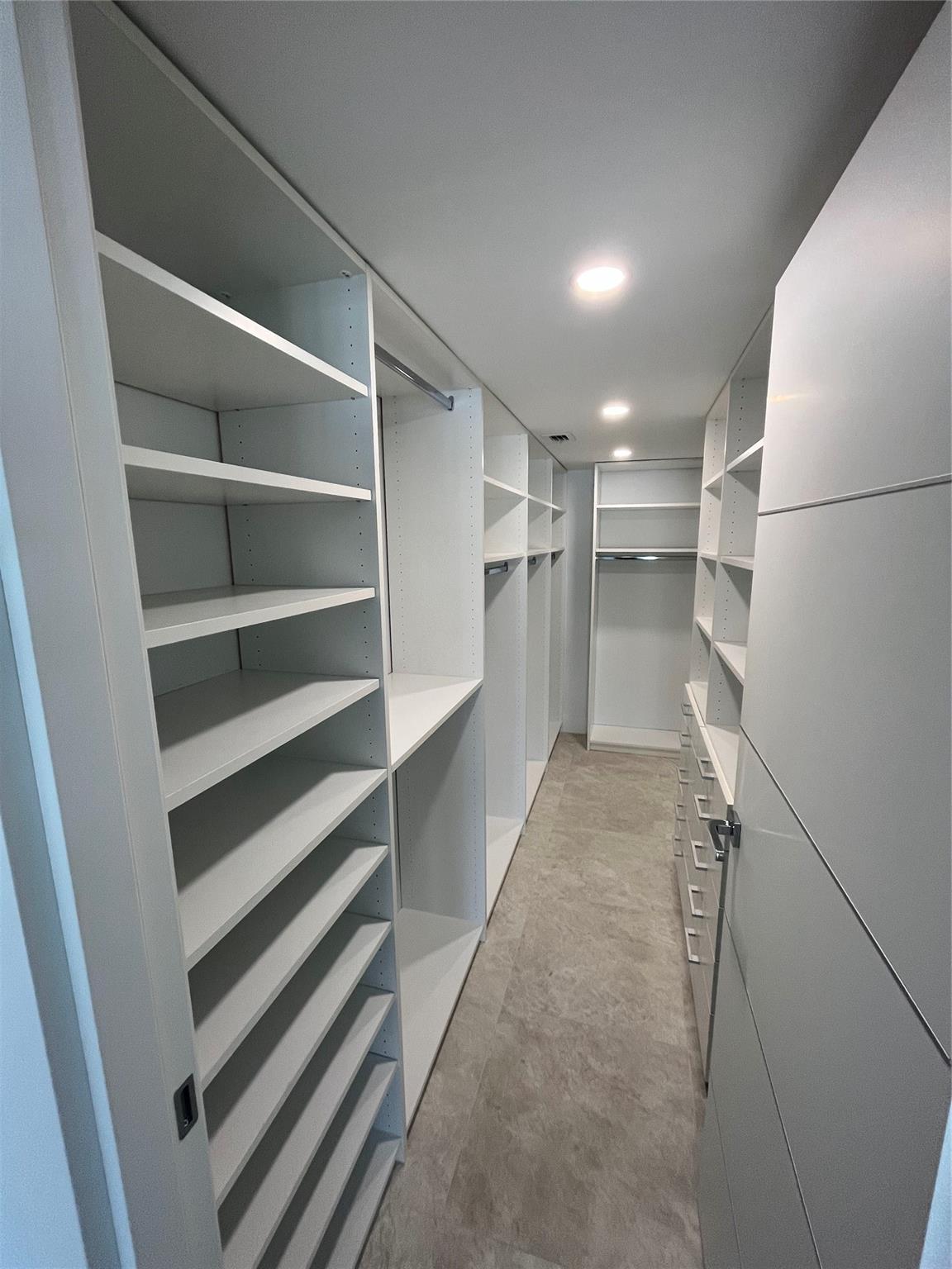 The master bedroom includes a large walk-in closet with custom built-in shelving.