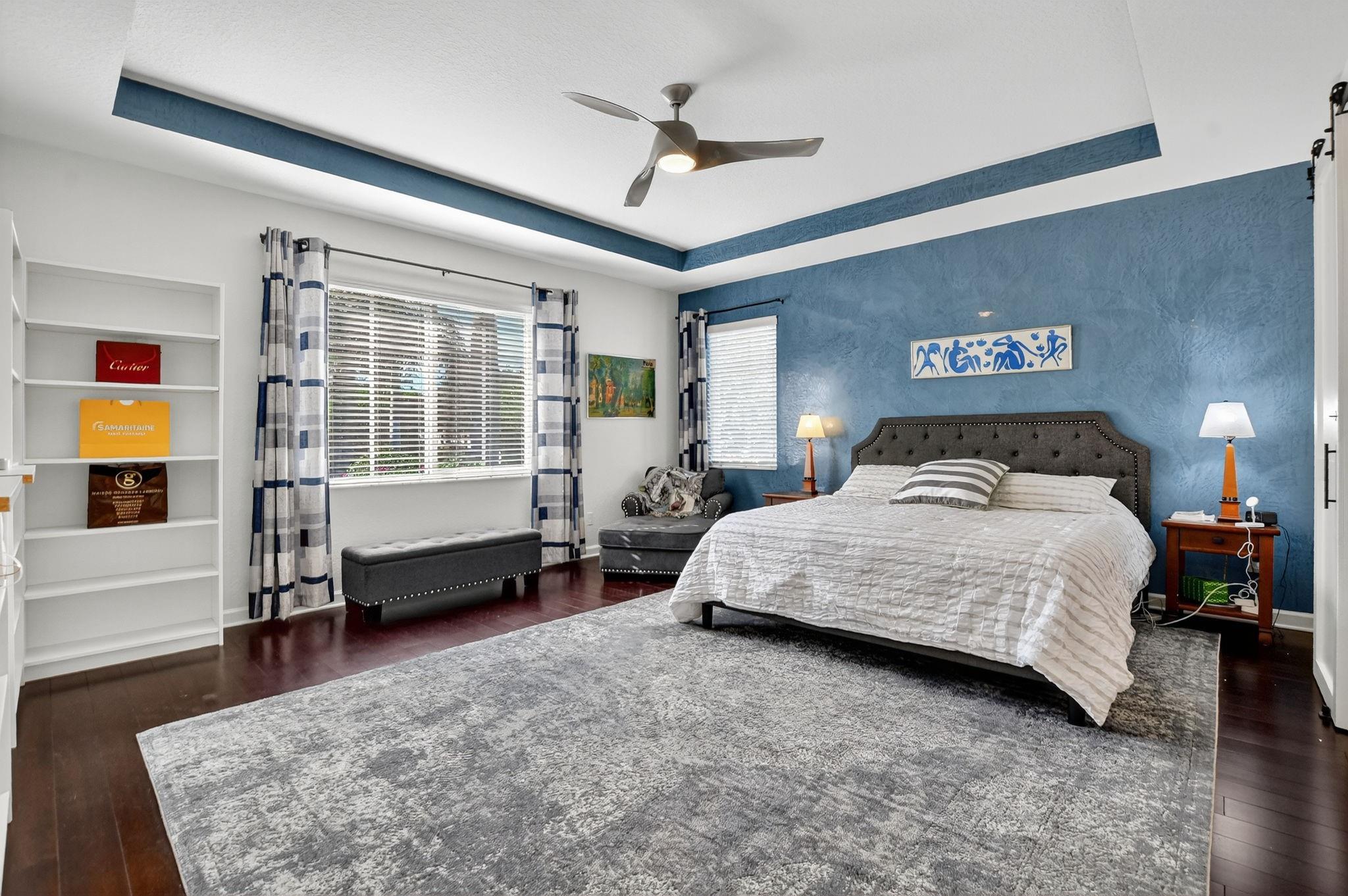 Gorgeous primary bedroom with Venetian Plaster accented wall.