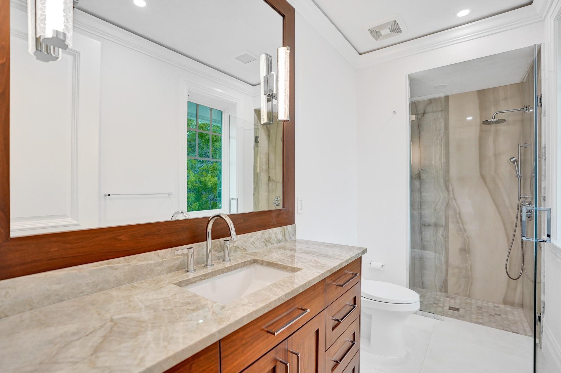 Spacious guest bedroom with walk-in closet and ensuite bathroom.