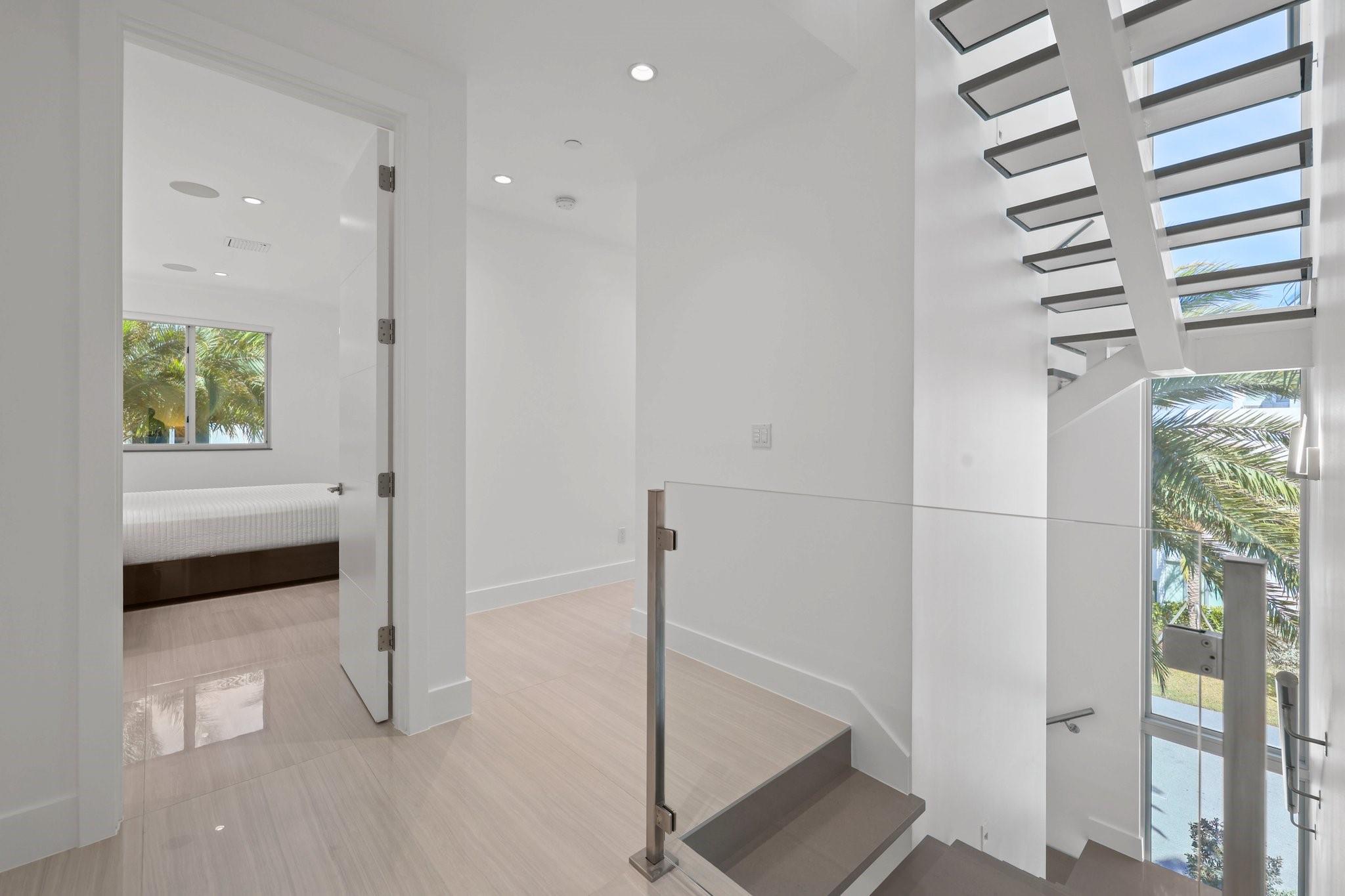 Floating staircase, large windows and glass railings create amazing landings