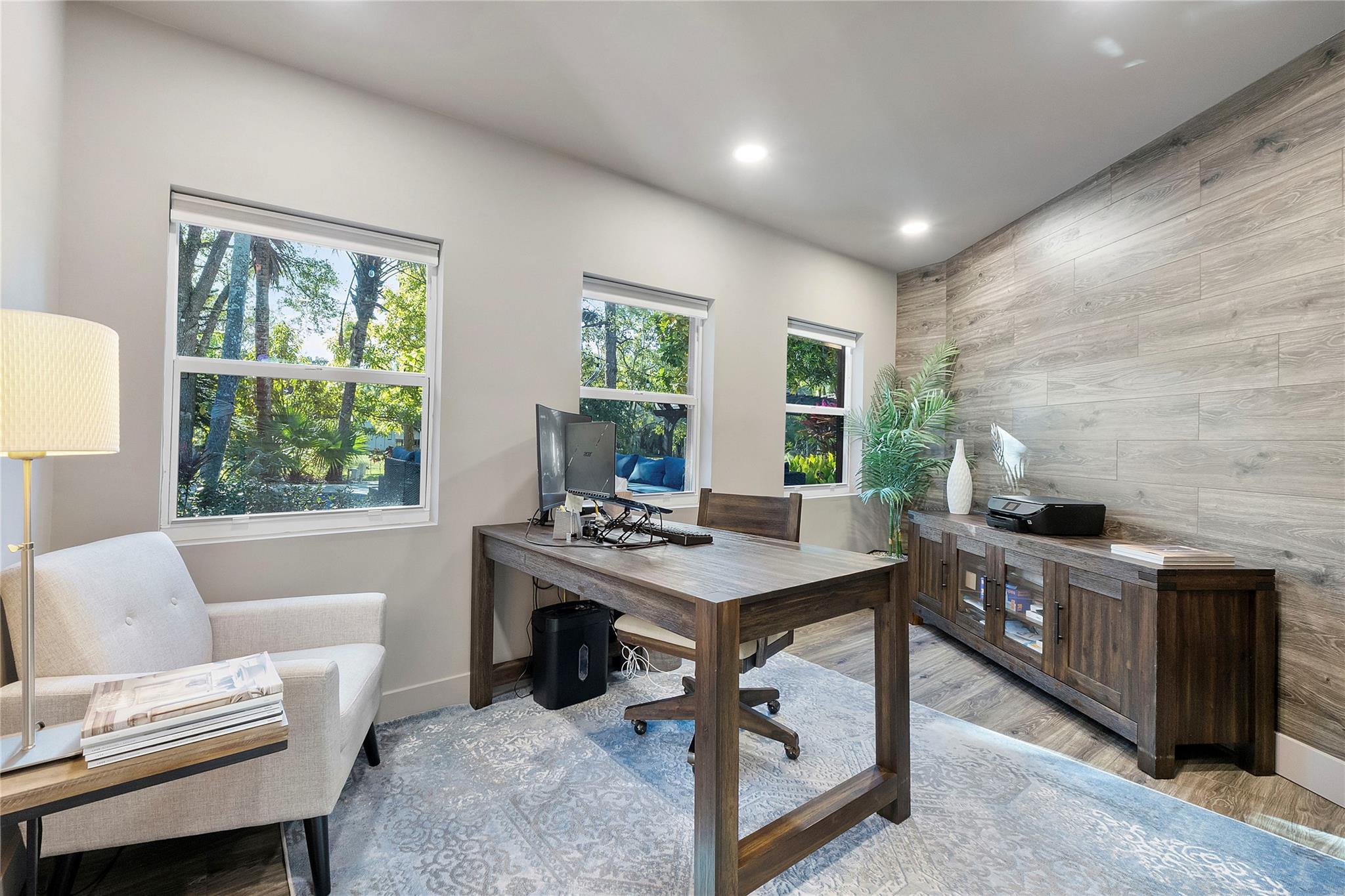 This private office is nestled in the back of the home with a special accent wall & LED lighting,The serene views of the pool and back garden of nature and pretty variety of birds and butterflies through your window.