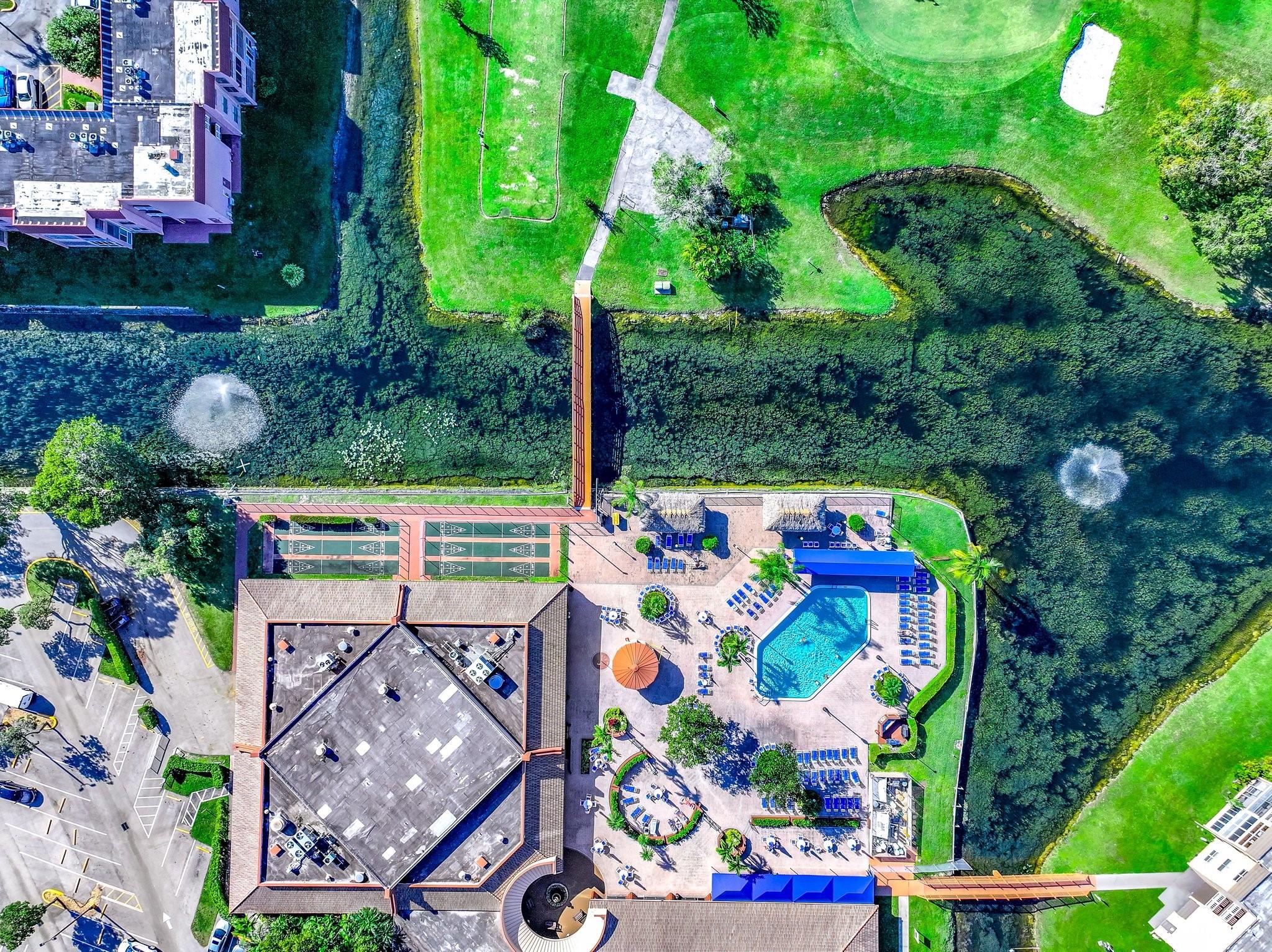 Photo for 9741 Sunrise Lakes Boulevard, 202, Sunrise, FL 33322 - Listing #FX-10478821 Aerial view of clubhouse with outdoor pool,shuffleboard