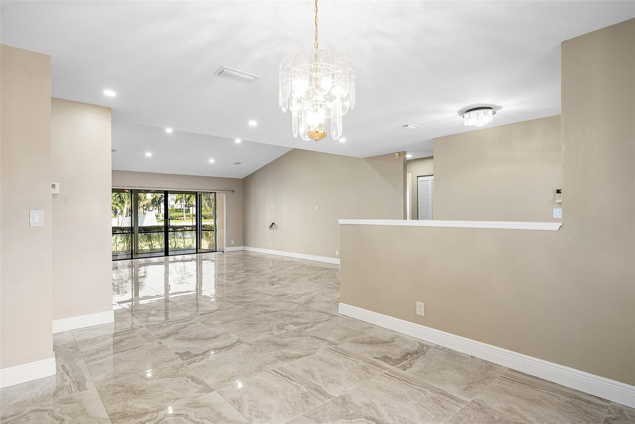 View from dining area to great room and back patio space.