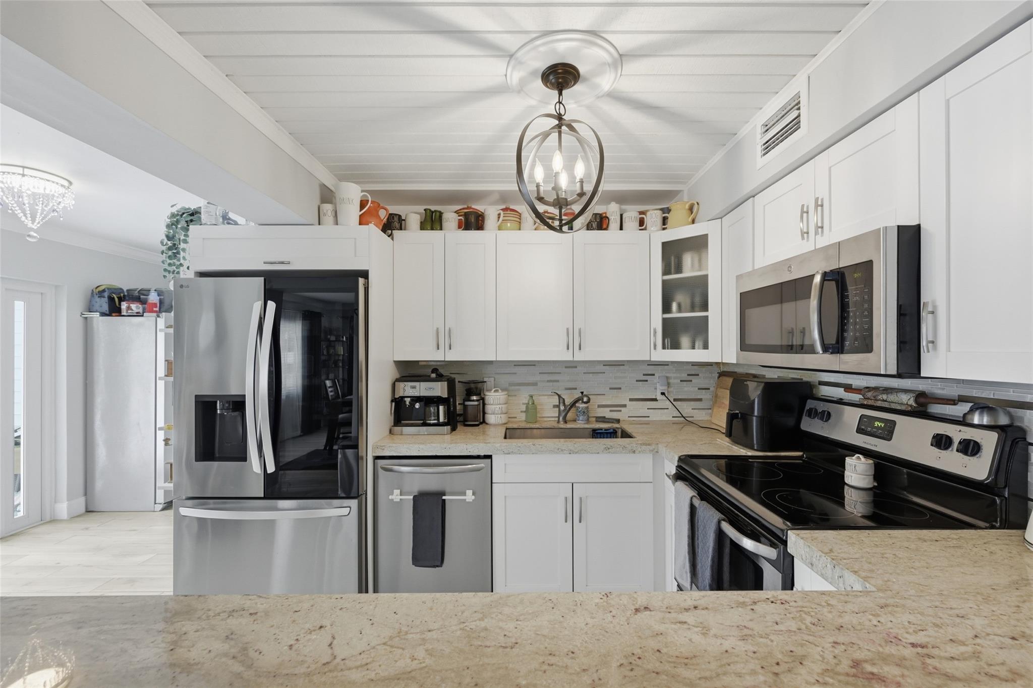 Open kitchen with stainless steel appliances that were new in 2020. Nice natural looking quarts counter tops.