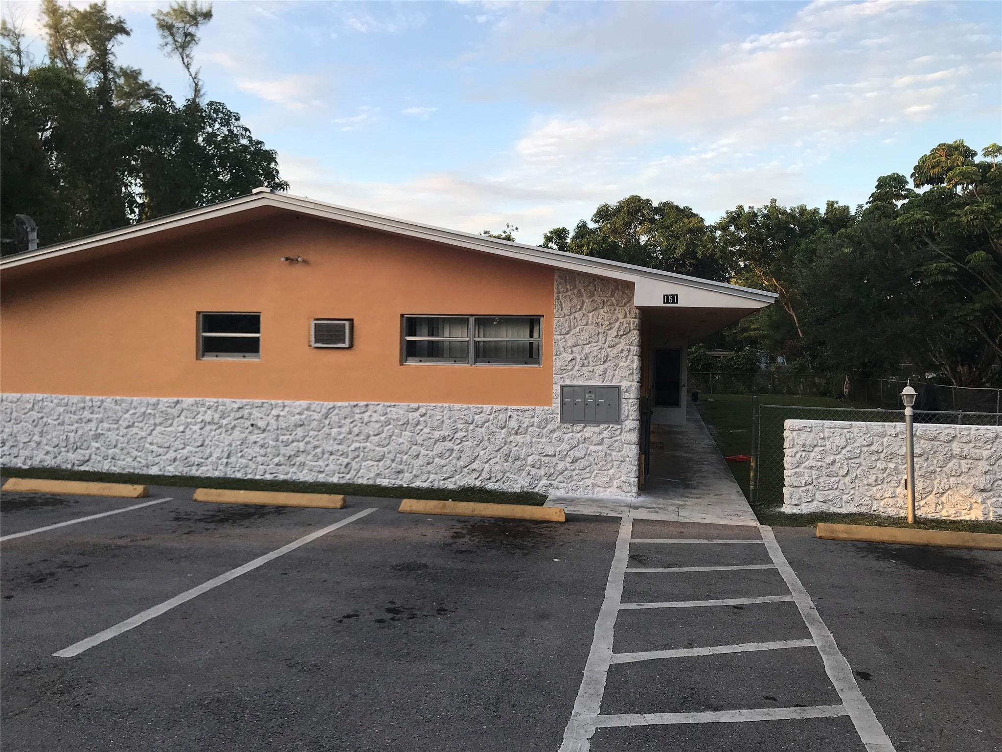 Photo for 161 NW 164th Street, 3, Miami, FL 33169 - listing #FX-10536757 Parking area and the front of the building