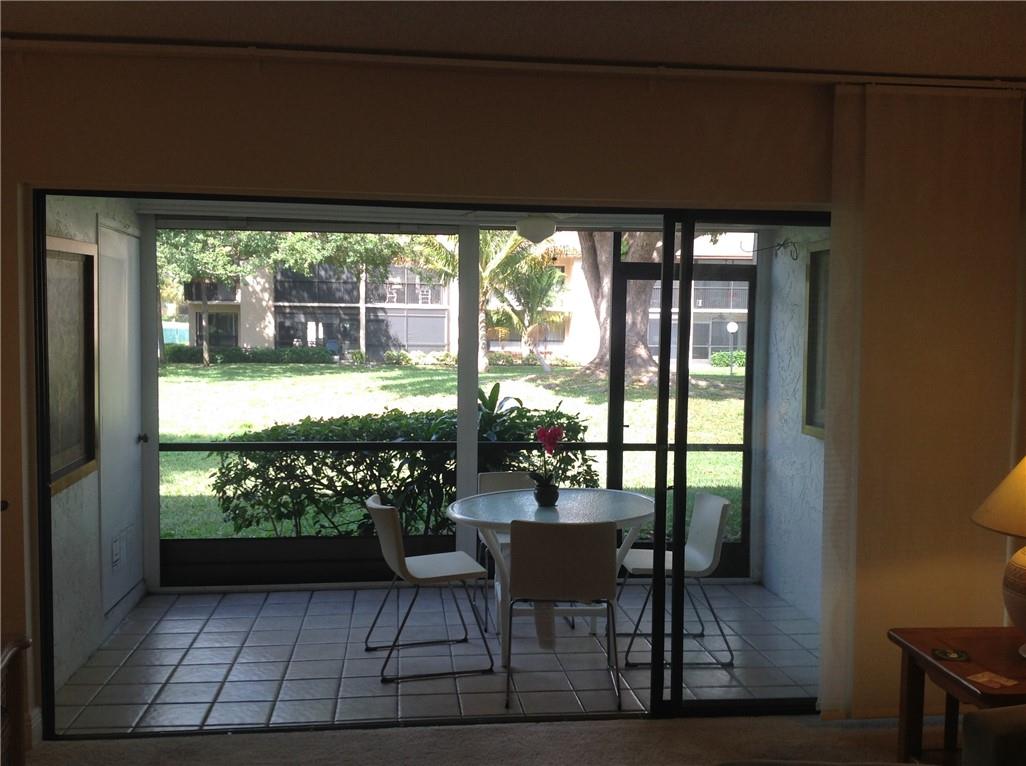 Screened in Patio with peaceful garden view, also storage unit inside.