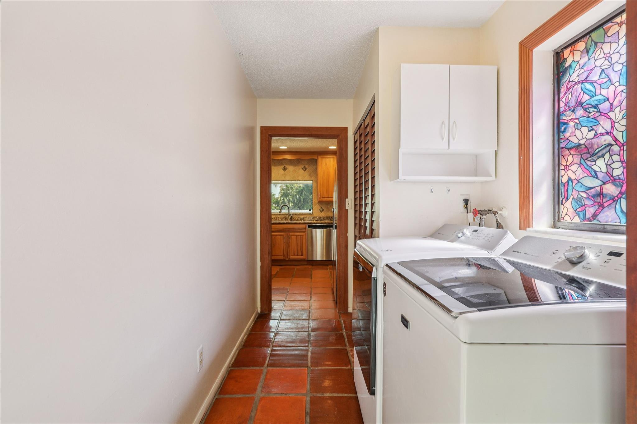 Separate laundry room off kitchen leading to garage.