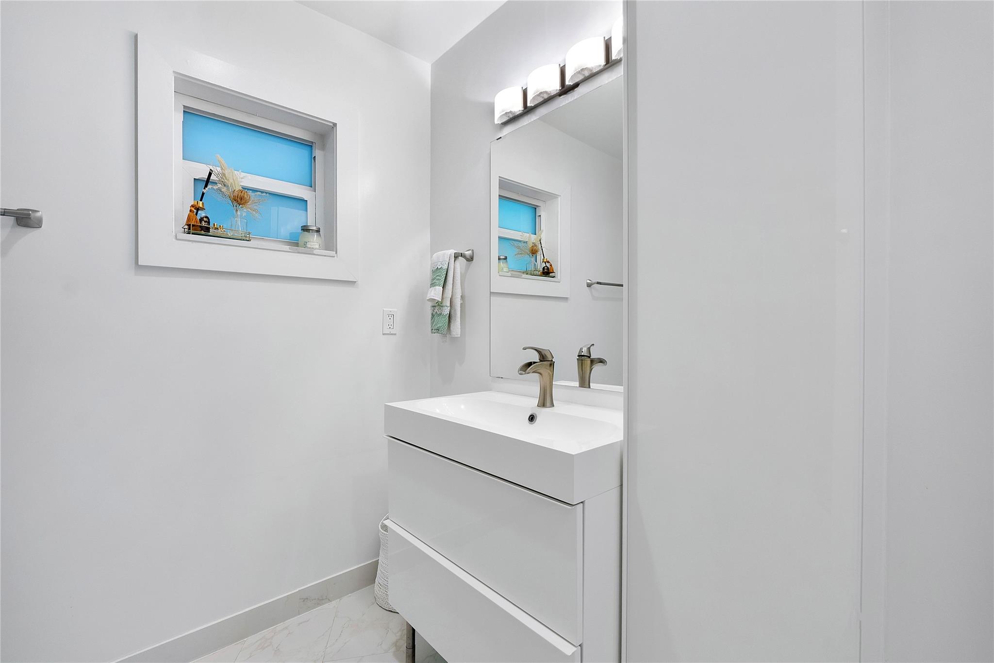 One of the guest bathrooms all in white ready for you to add some color in towels and decor