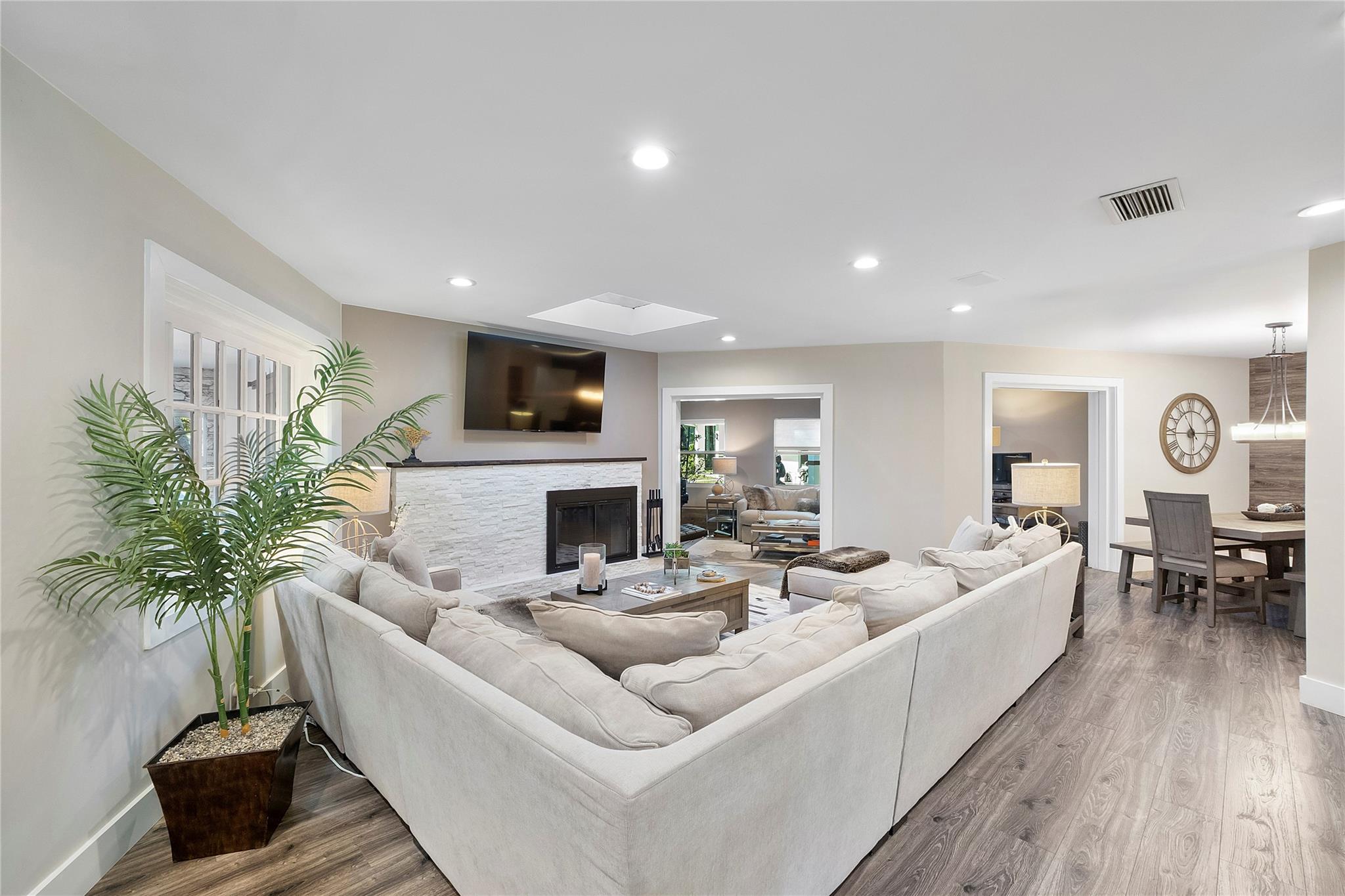 Huge living room with a stylish modern fireplace for those chilly movie nights by the fire, Can you see the open floorplan and all the open rooms that are adjacent to the living room?there is another beauty to the left of the couch also, such a pretty home