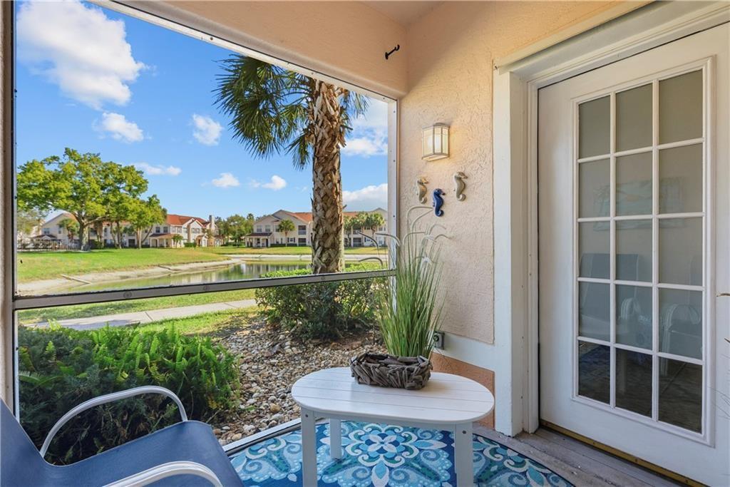 Screen porch featuring a water view and a residential view
