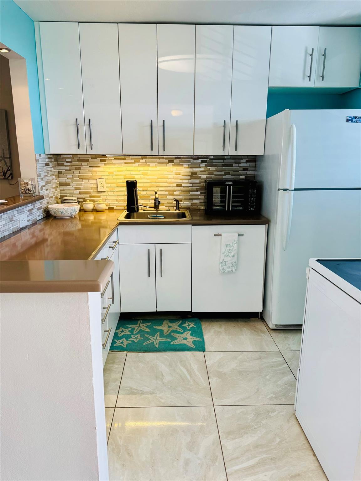 Nicely appointed Kitchen is open to social area.