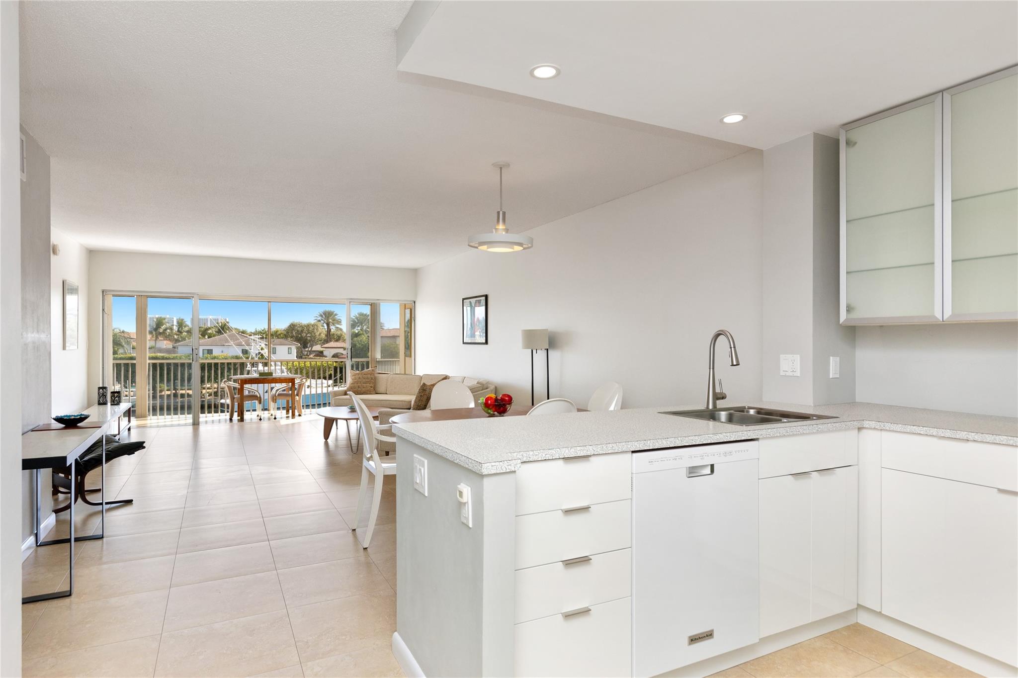 Kitchen in foreground with dining and living areas in background to gorgeous views.