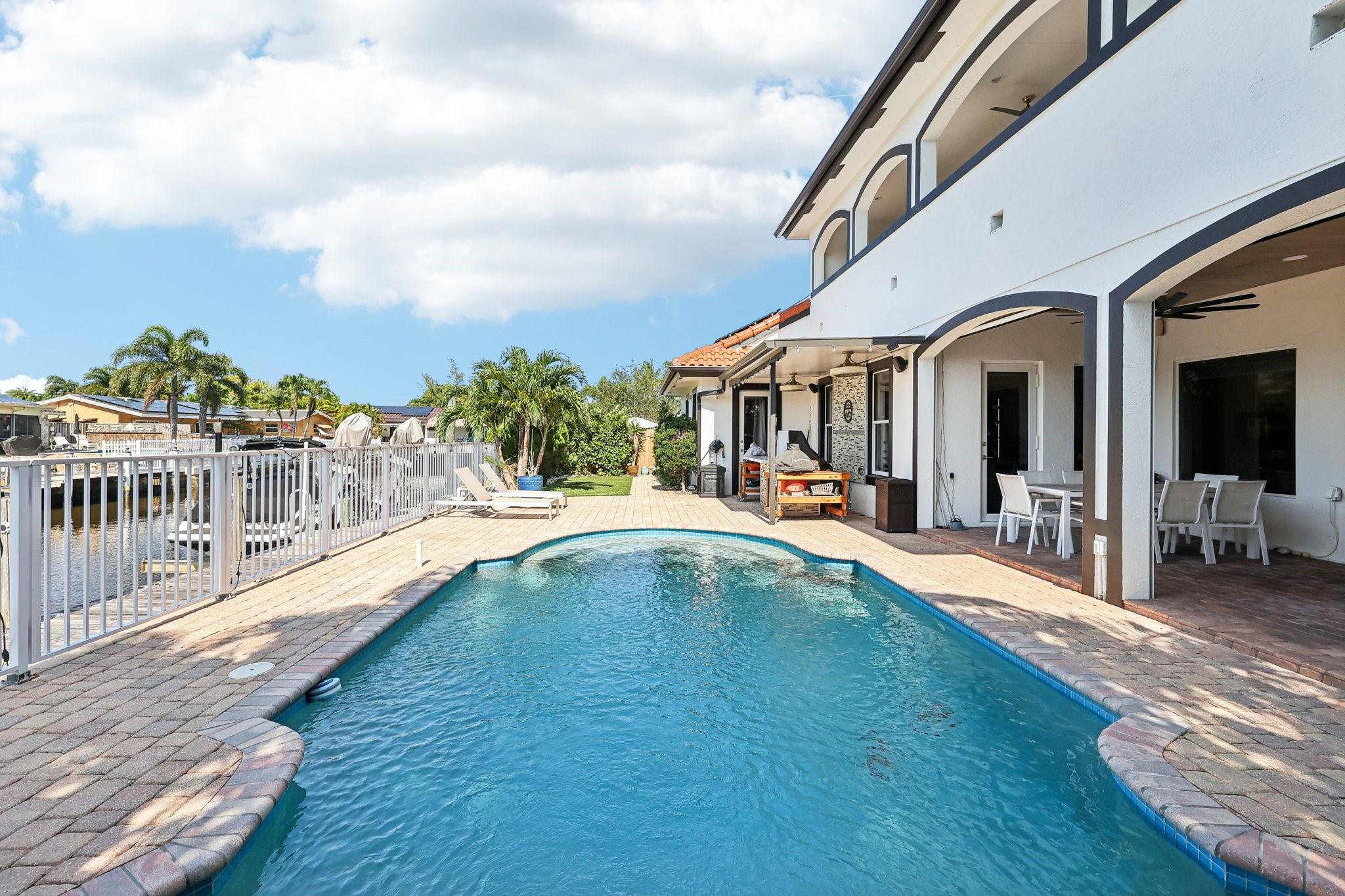 Enjoy the luxury of a 19,000-gallon heated saltwater pool, designed for both relaxation and style. This custom pool features a whimsical painted swimsuit motif at the bottom, adding a unique and playful touch. Perfectly complemented by the surrounding patio area, it offers year-round enjoyment with low-maintenance saltwater technology and energy-efficient heating. Enjoy the luxury of a 19,000-gallon heated saltwater pool, designed for both relaxation and style. This custom pool features a whimsical painted swimsuit motif at the bottom, adding a unique and playful touch. Perfectly complemented by the surrounding patio area, it offers year-round enjoyment with low-maintenance saltwater technology and energy-efficient heating.