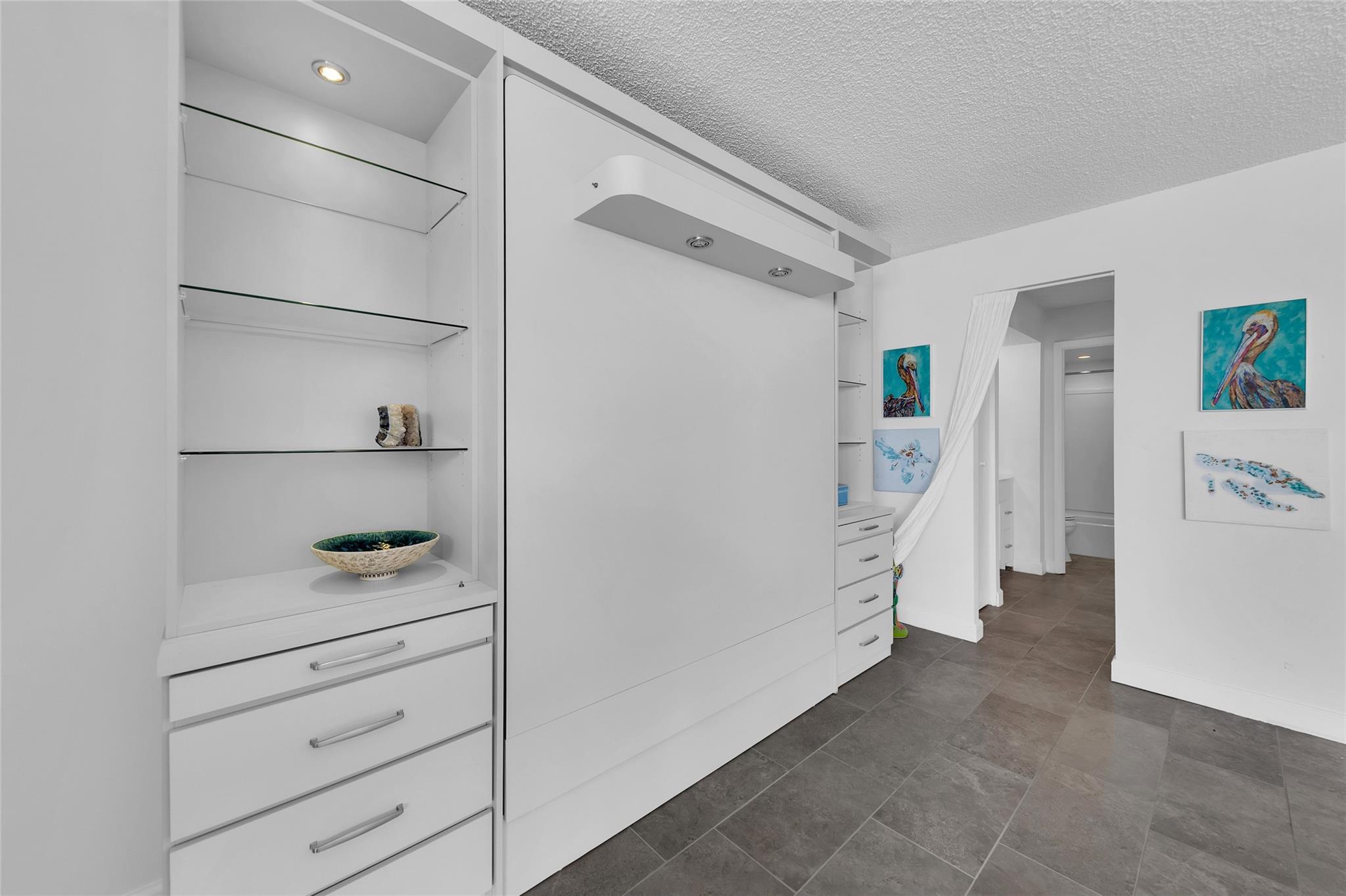 The hidden Murphy bed proximity to bathroom suite