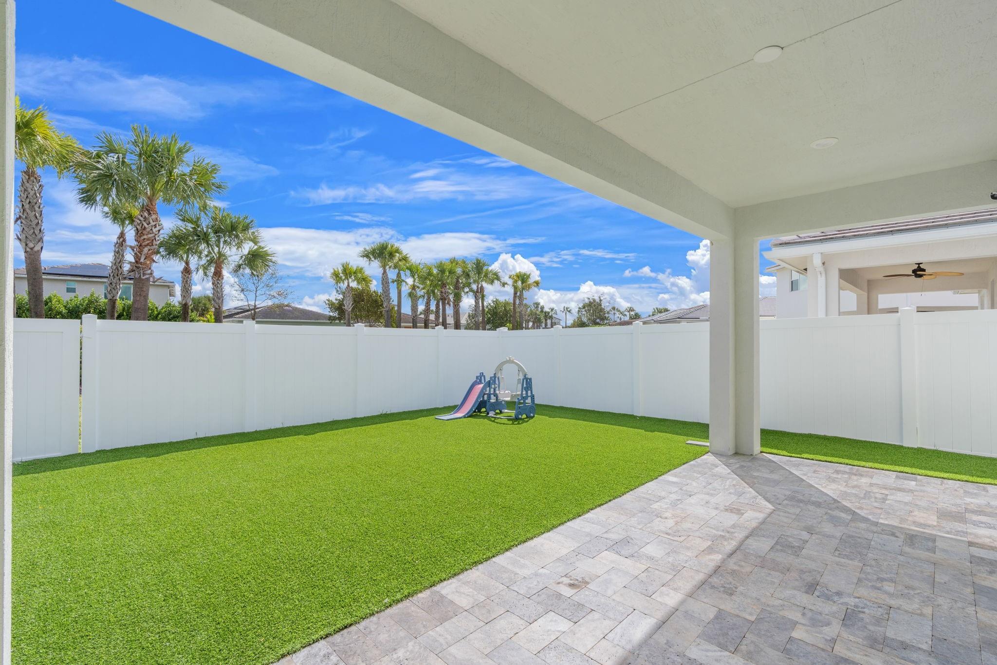 Privacy and the Convenience of Travertine Patio and Artificial Turf in a Fully Fenced Back and Side Yards.
