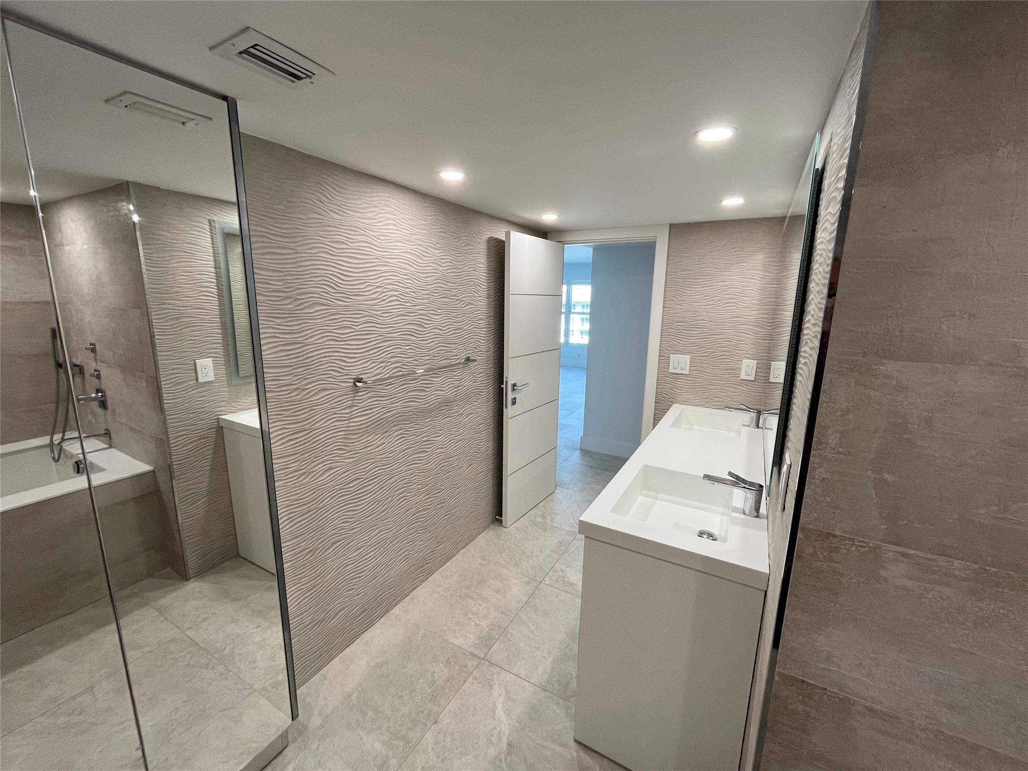 Additional storage in the master bathroom behind the mirrored sliding glass doors.