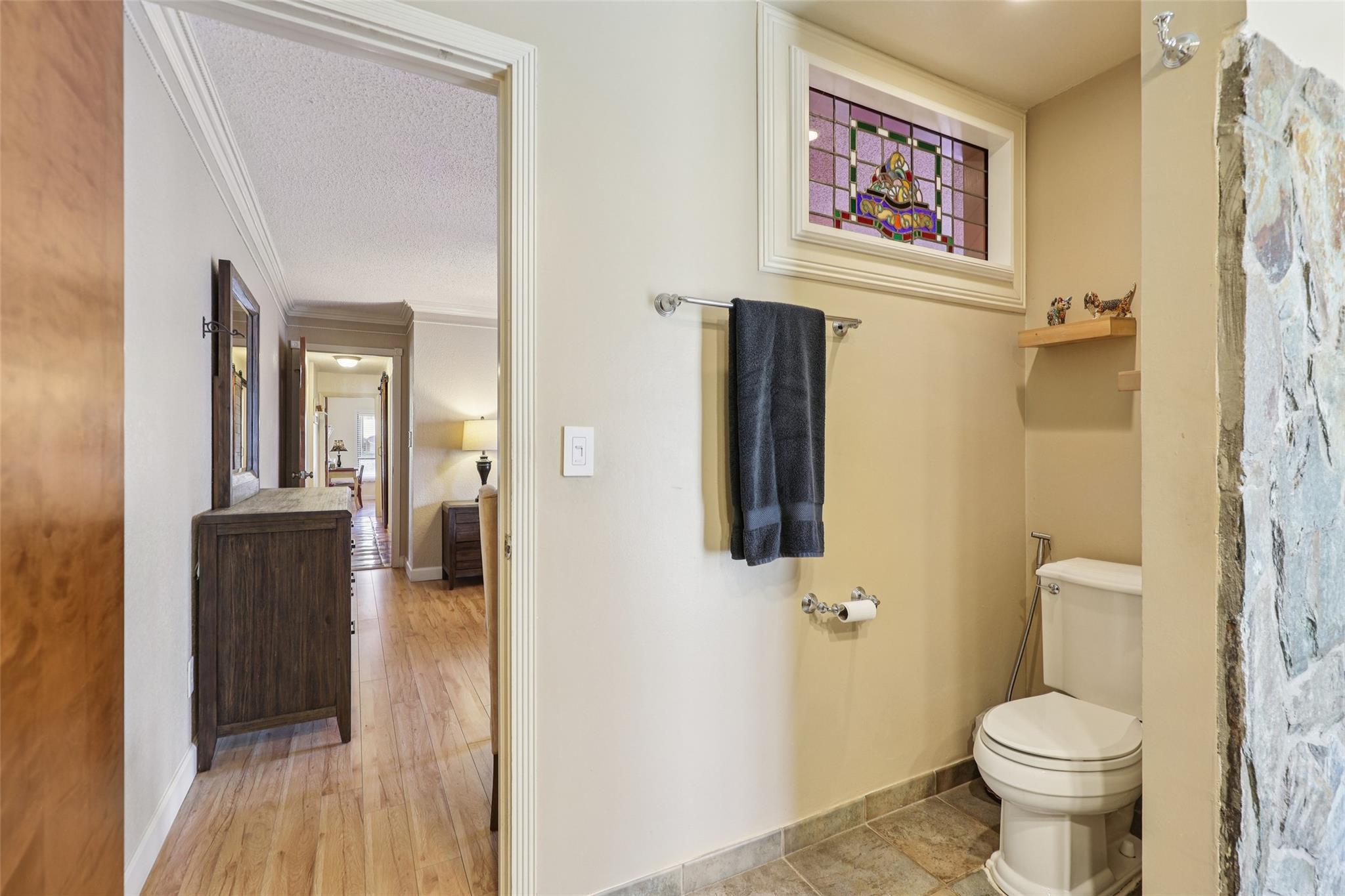 Roomy primary bathroom is a convenient en suite to primary bedroom.