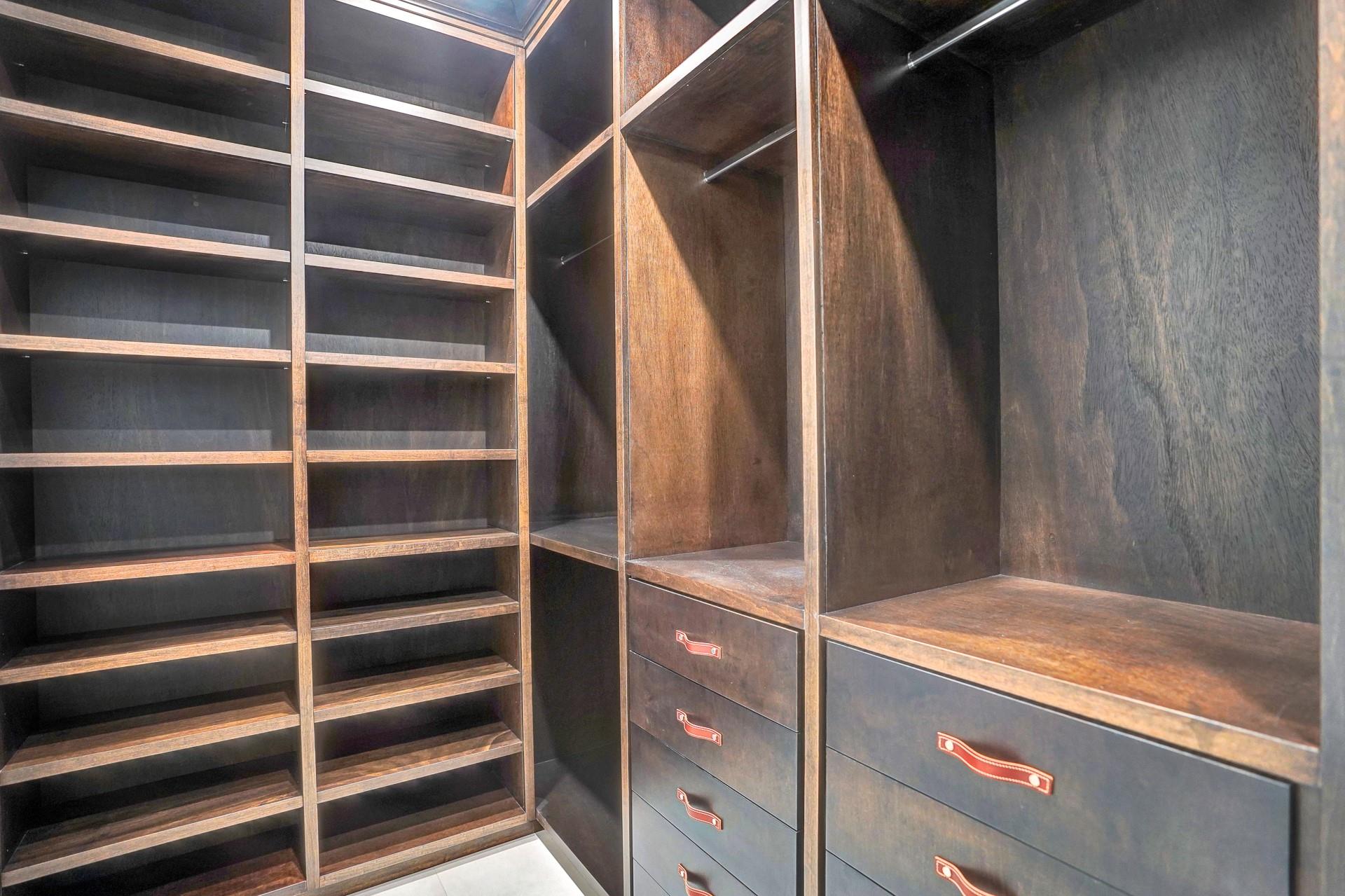 The primary suite boasts separate his-and-hers bathrooms; his bathroom includes a stylish vanity and a large walk-in closet.