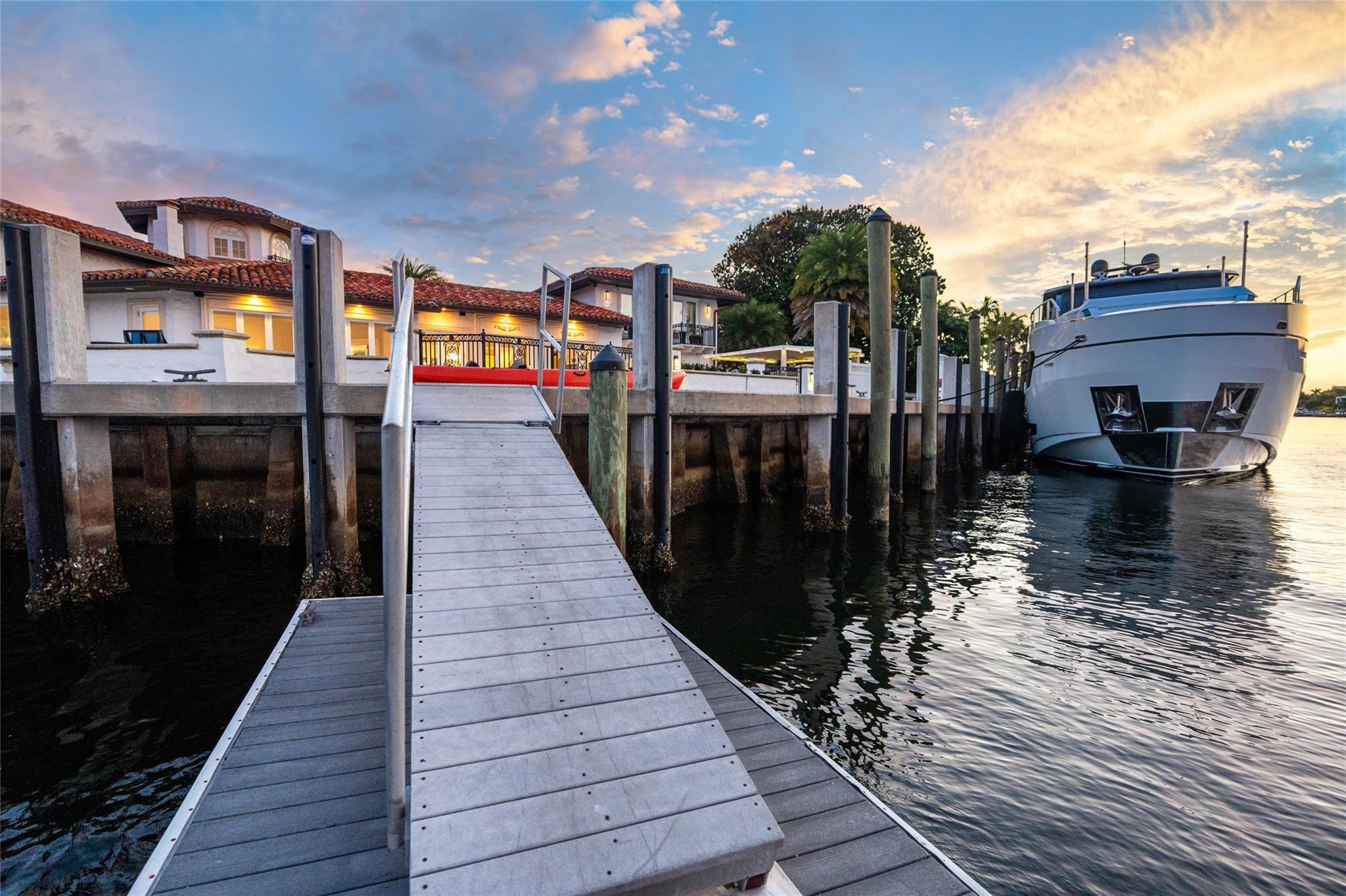 A private deep-water dock extending into calm, protected waters, perfectly positioned for large yachts and effortless ocean access. Framed by breathtaking sunset skies, this premier dockage completes the ultimate Fort Lauderdale waterfront lifestyle.