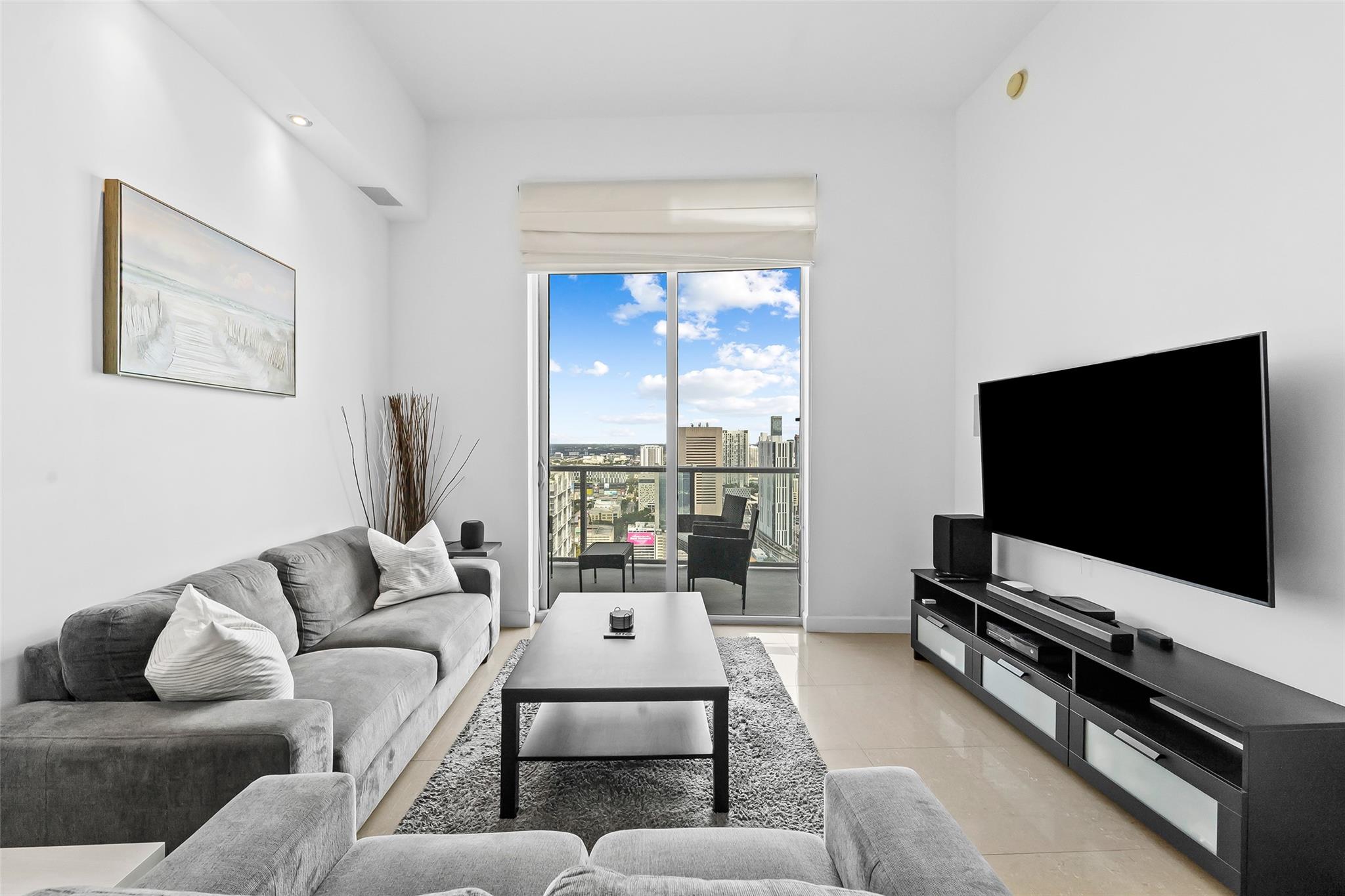 Living Space that looks out to the balcony, facing North