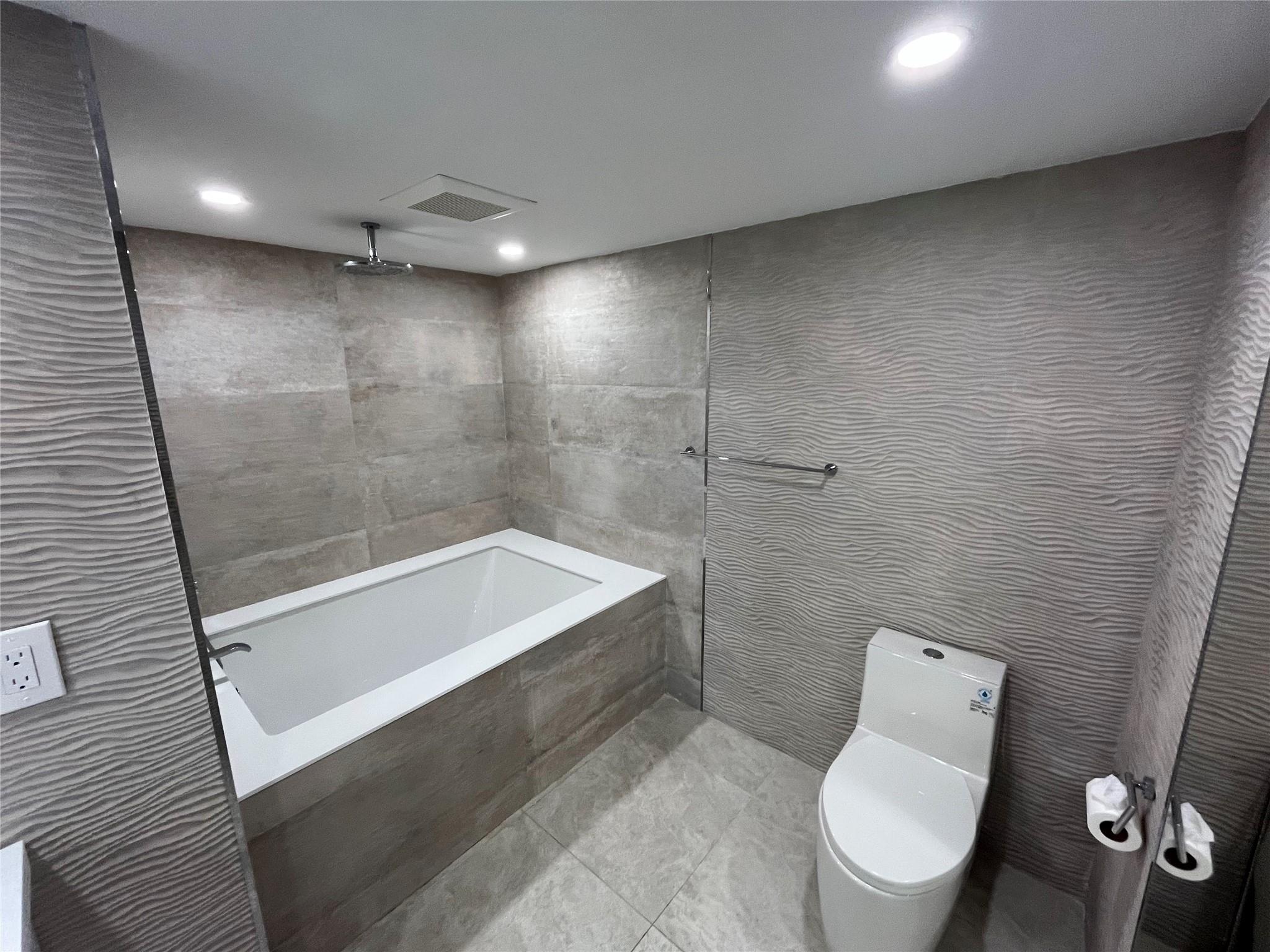 A deep soaking tub in the master bathroom.