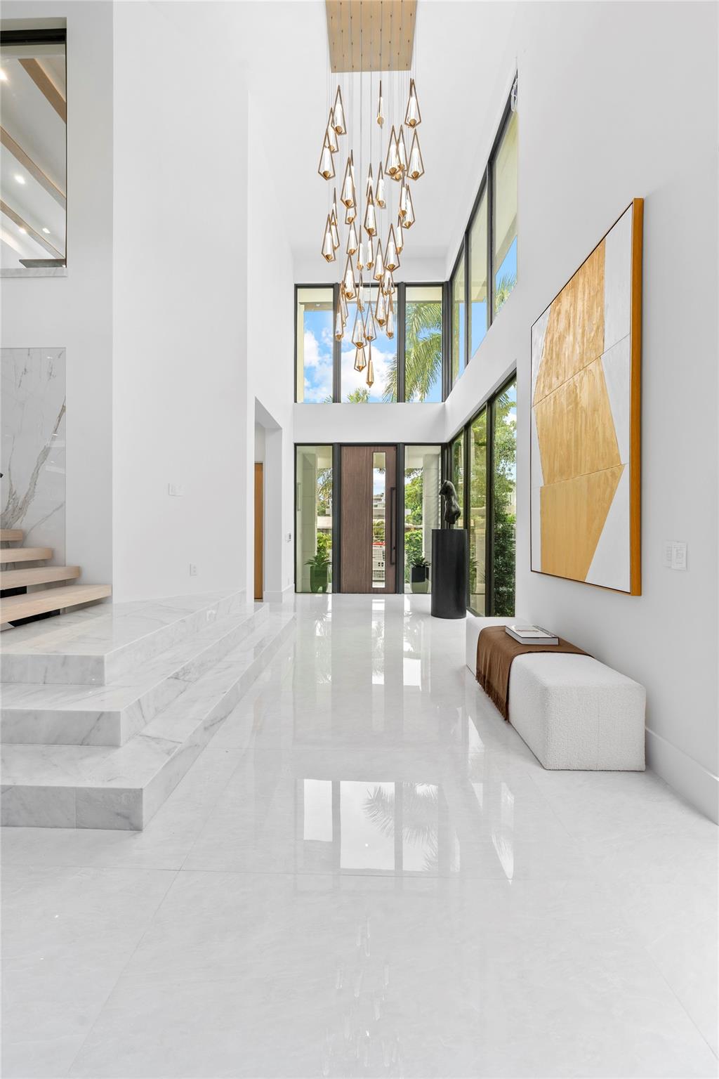As you enter the home, you’re greeted by soaring open ceilings and a stunning foyer chandelier that sets the tone for the elegance found throughout the residence.