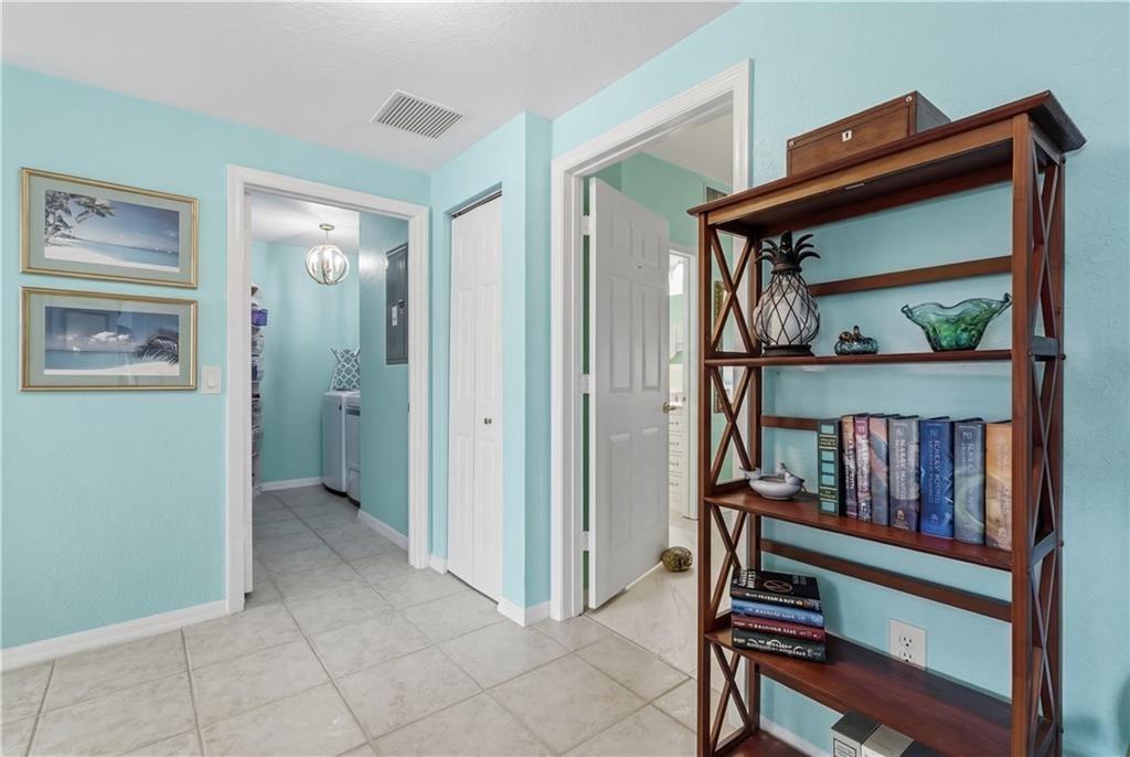 Hall with baseboards and tile patterned flooring