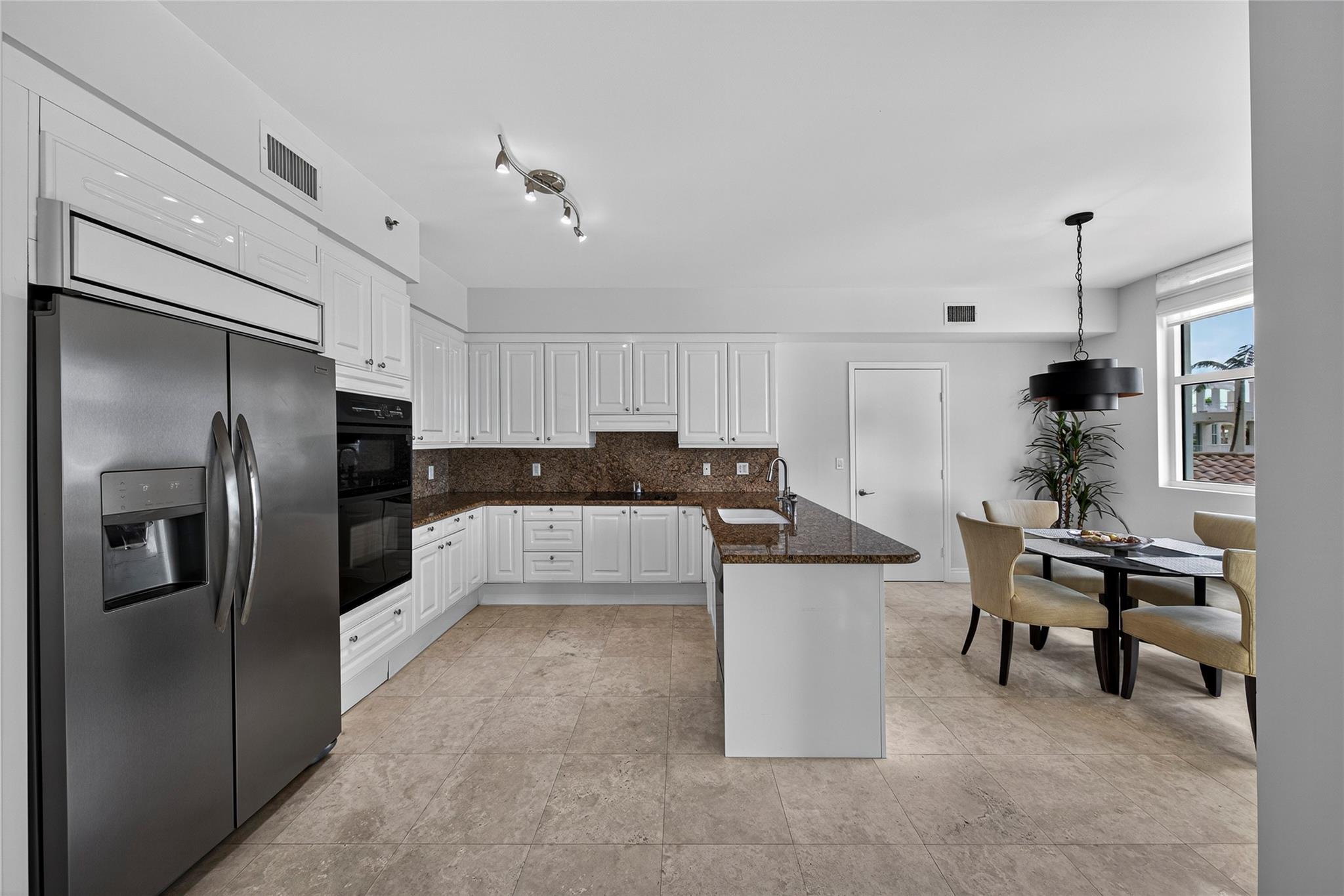 Updated kitchen with stainless steel refrigerator