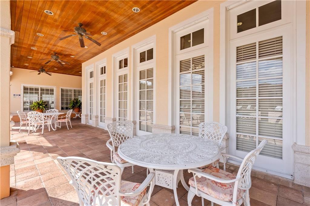 View of patio with outdoor dining space and a ceiling fan