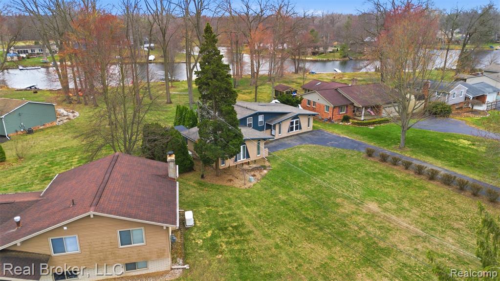 Aerial view of property and surrounding area featuring a large body of water
