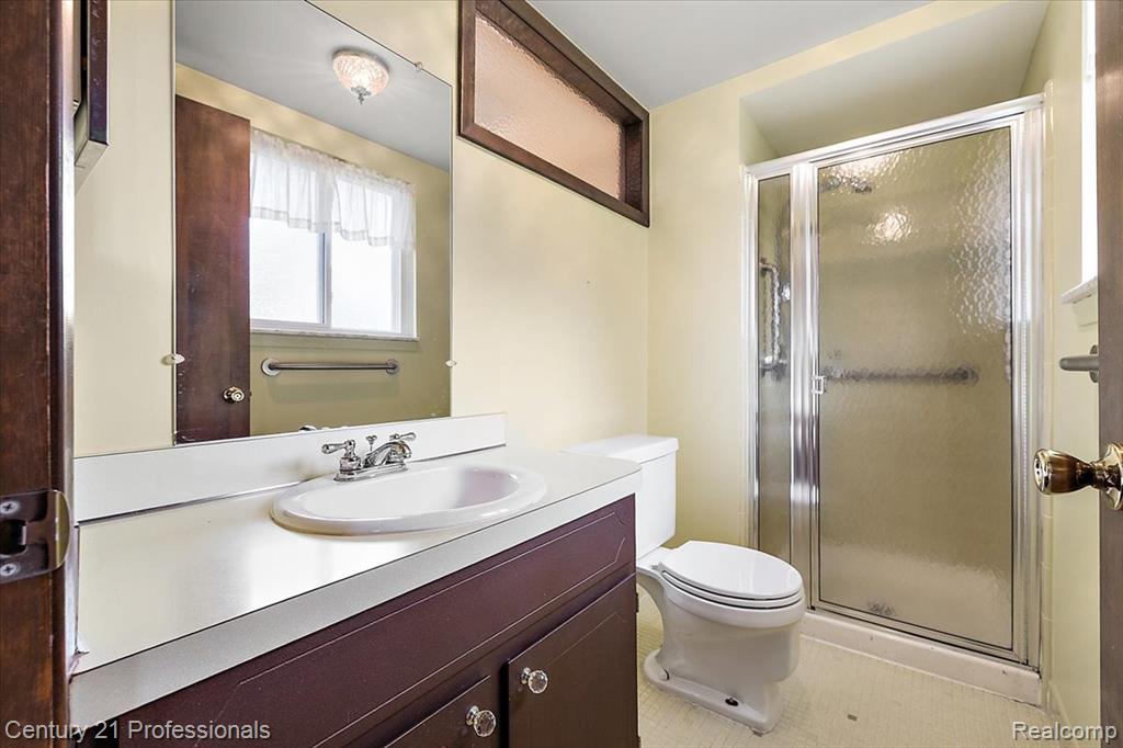 Bathroom featuring vanity and a shower stall