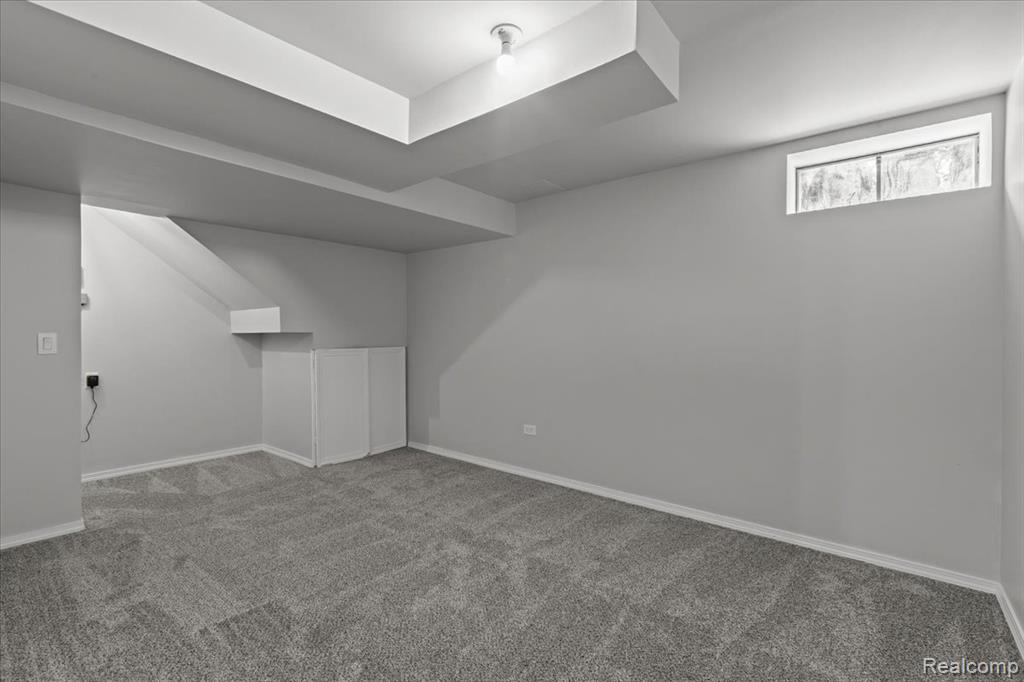 Snow covered rear of property with brick siding