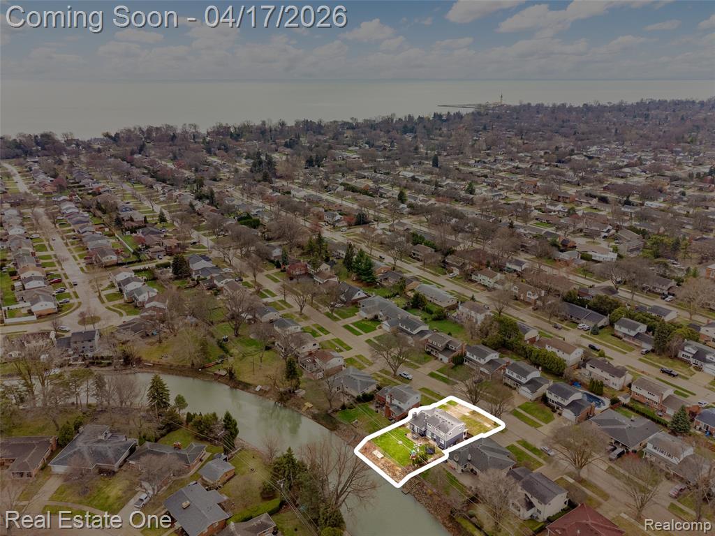 Aerial perspective of suburban area with a nearby body of water
