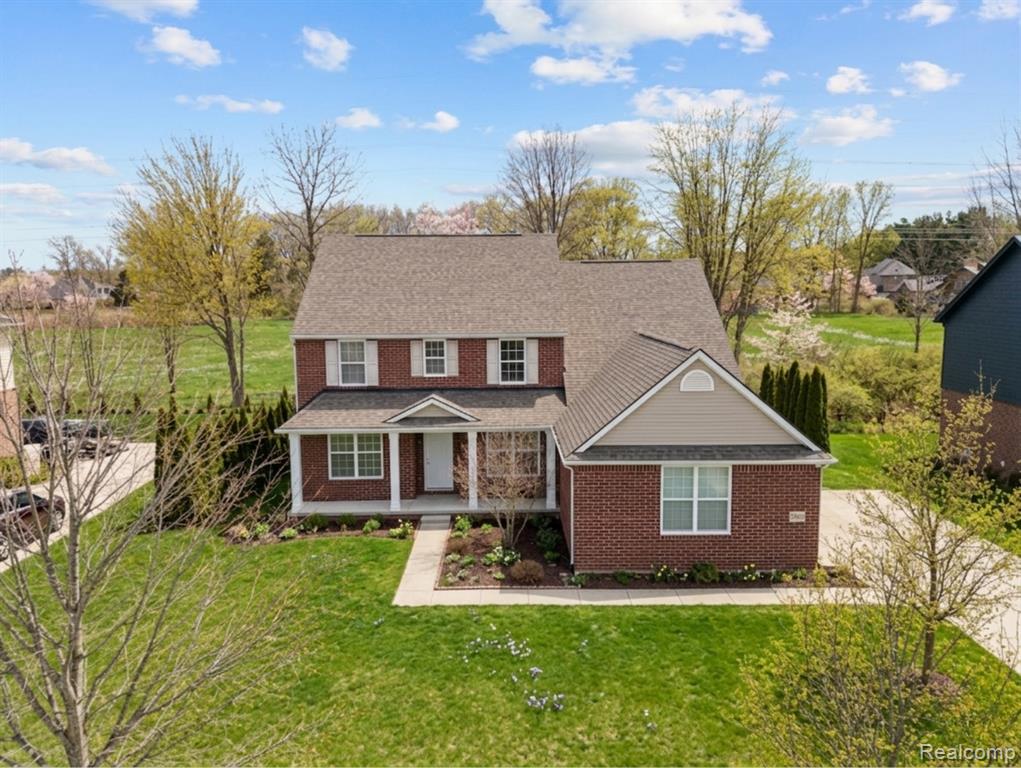 View of front of property with brick siding and covered porch