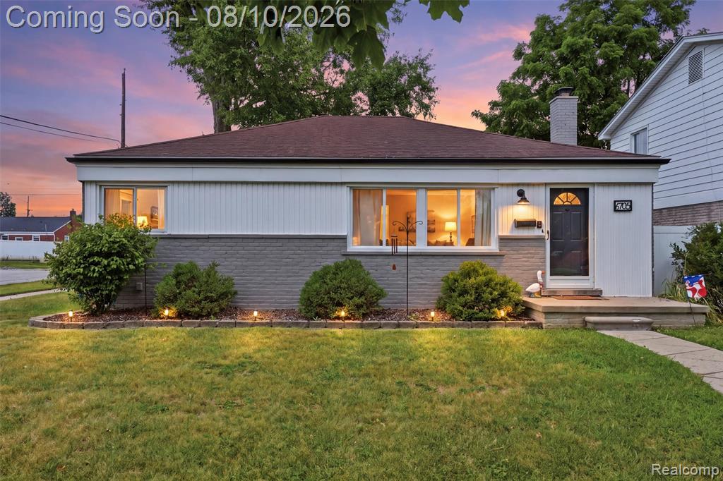 Brick and siding exterior with a dark asphalt shingle roof