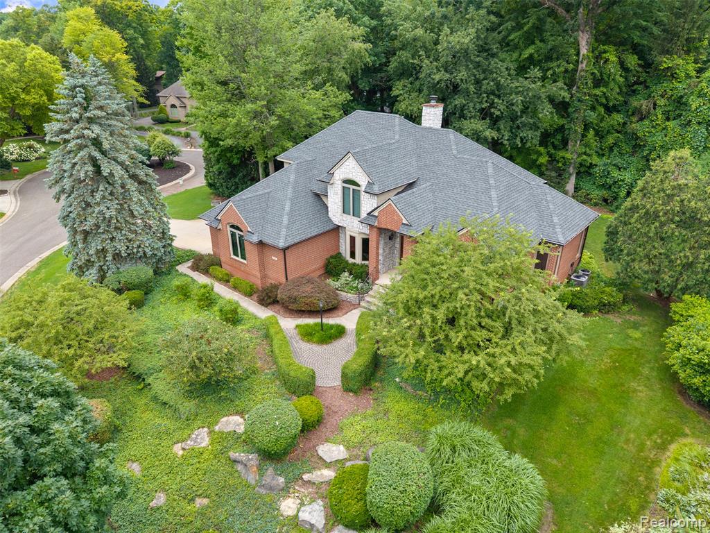 View from above of property with a tree filled landscape