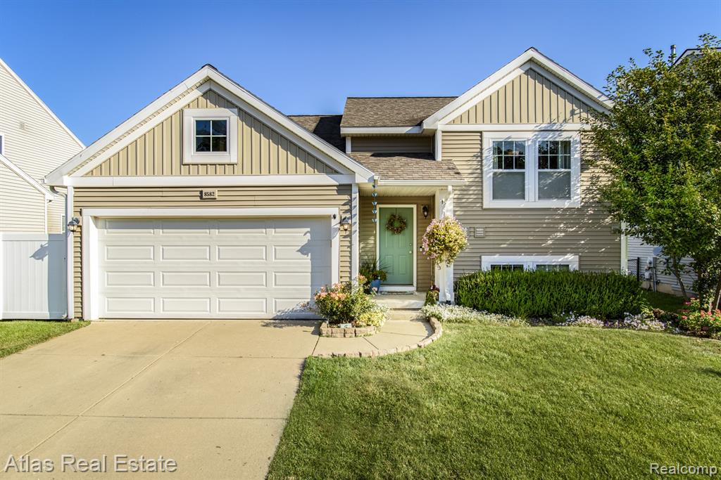 8582 Pinnebog River Drive, Fowlerville, MI 48836 — front exterior