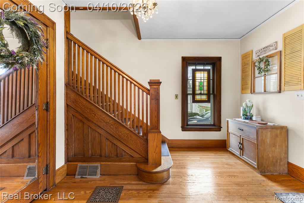Foyer featuring light wood-style floors and a chandelier