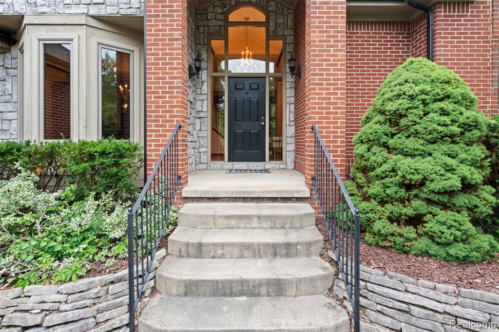 Property entrance featuring brick siding
