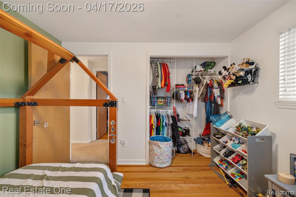 Bedroom featuring light wood-style flooring and a closet