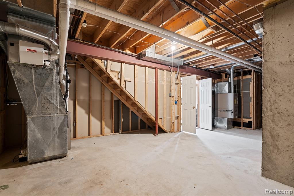 Unfinished basement featuring heating unit