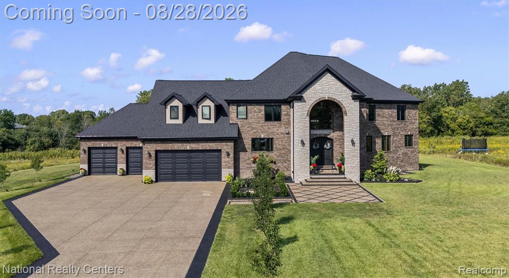 Brick and stone exterior with dark roofing