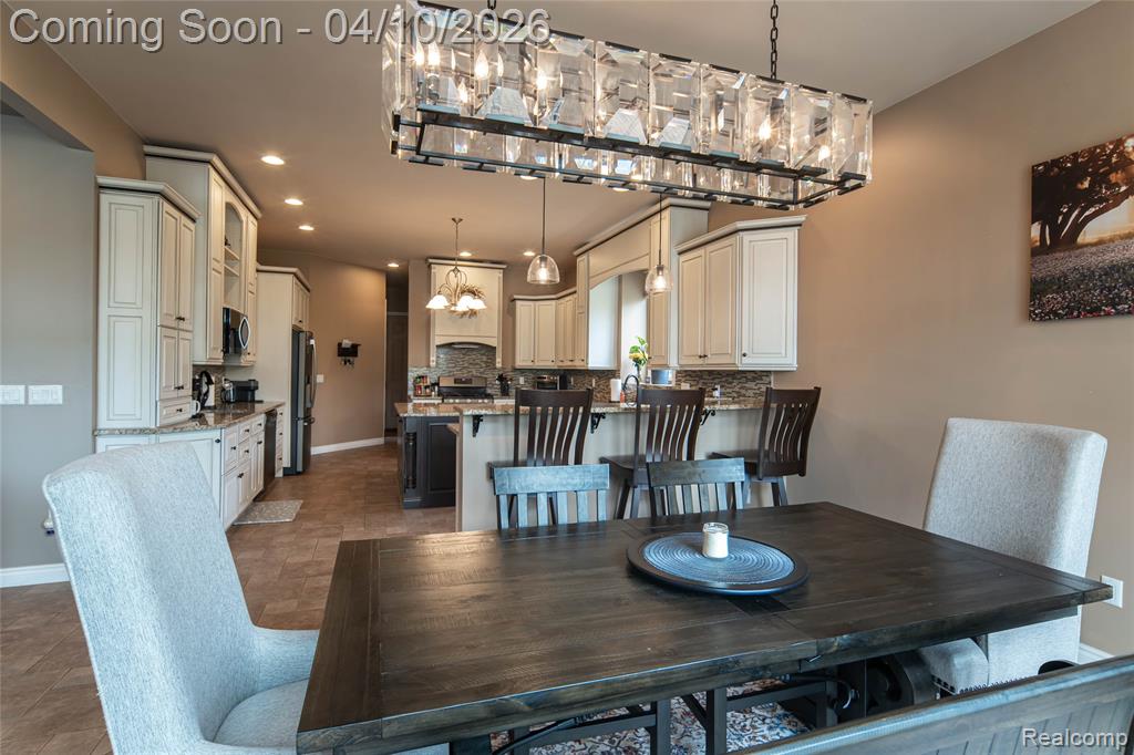 Dining space featuring a chandelier and baseboards